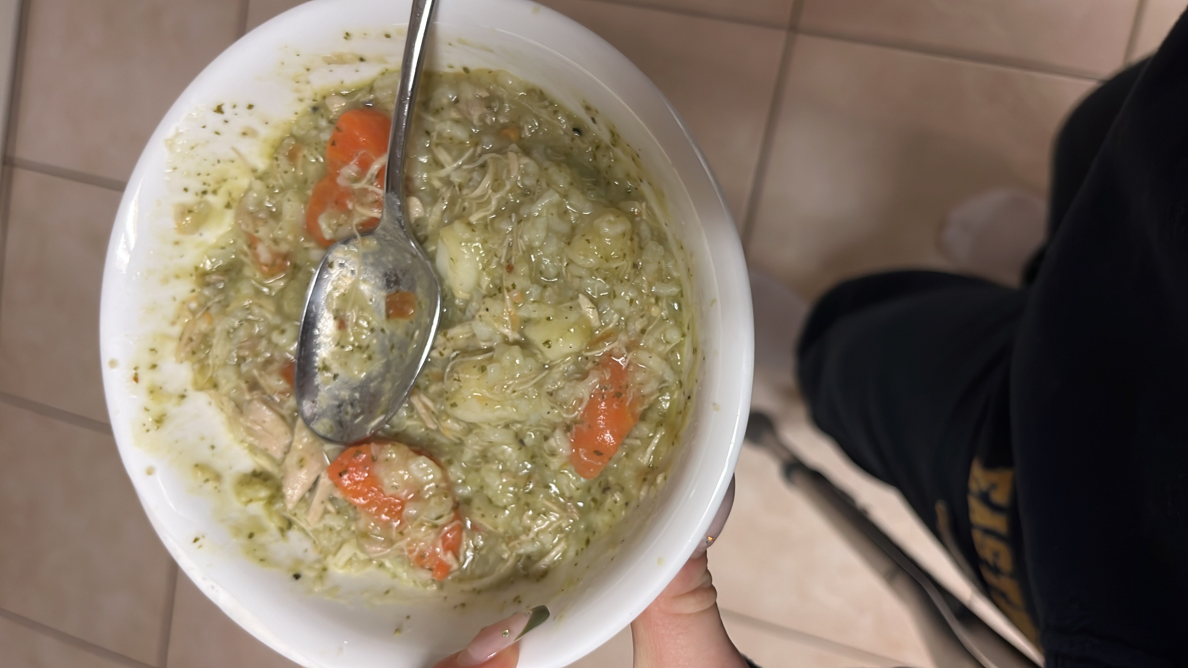 A hearty chicken and vegetable soup with carrots, potatoes, and herbs, providing a balanced mix of protein, carbs, and fats.