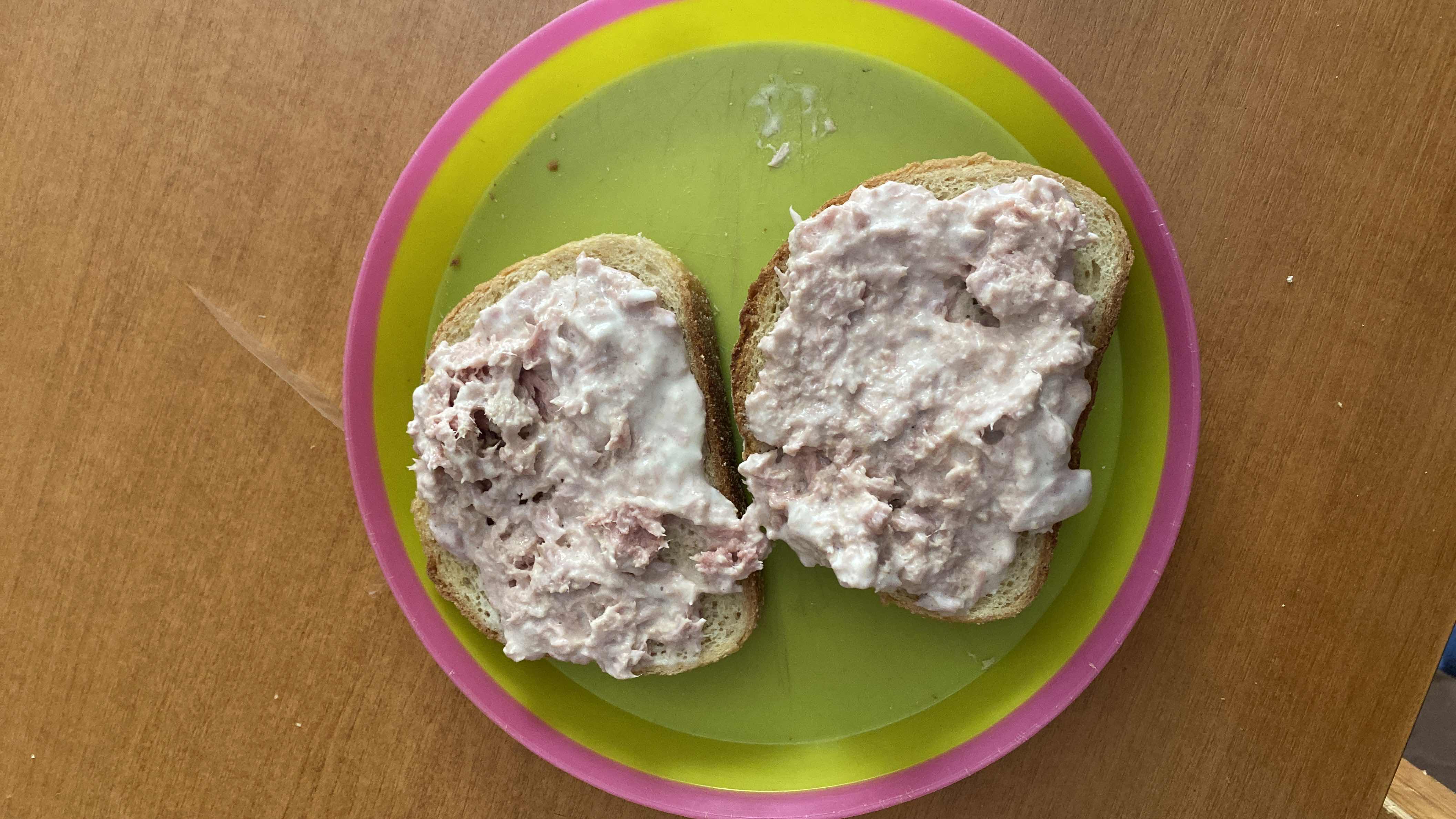 This is a simple dish consisting of two slices of bread topped with a tuna and mayonnaise mixture, providing a balanced amount of protein, carbs, and fats.