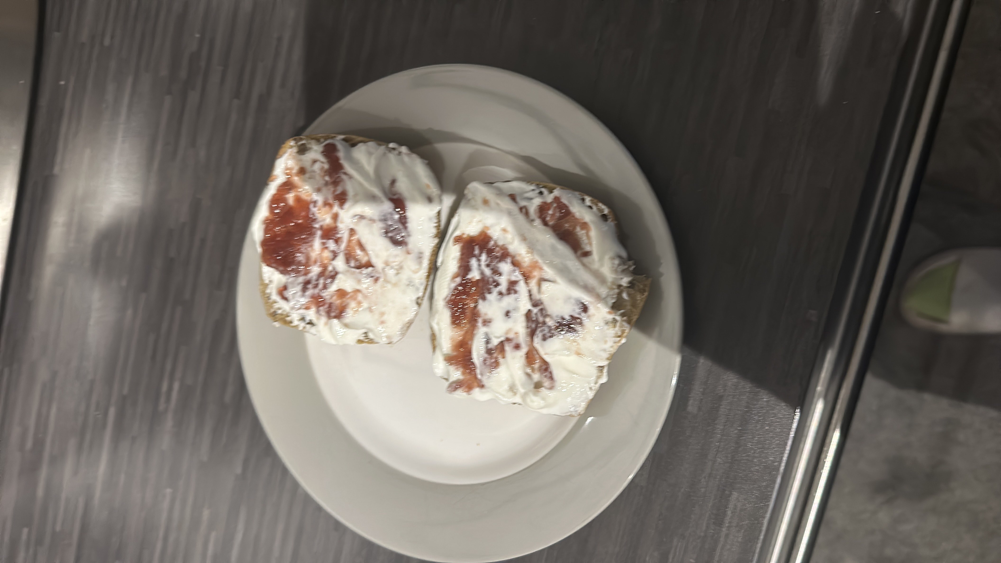 A plate with two slices of bread topped with skyr and jam, offering a balanced mix of carbohydrates, protein, and low fats.