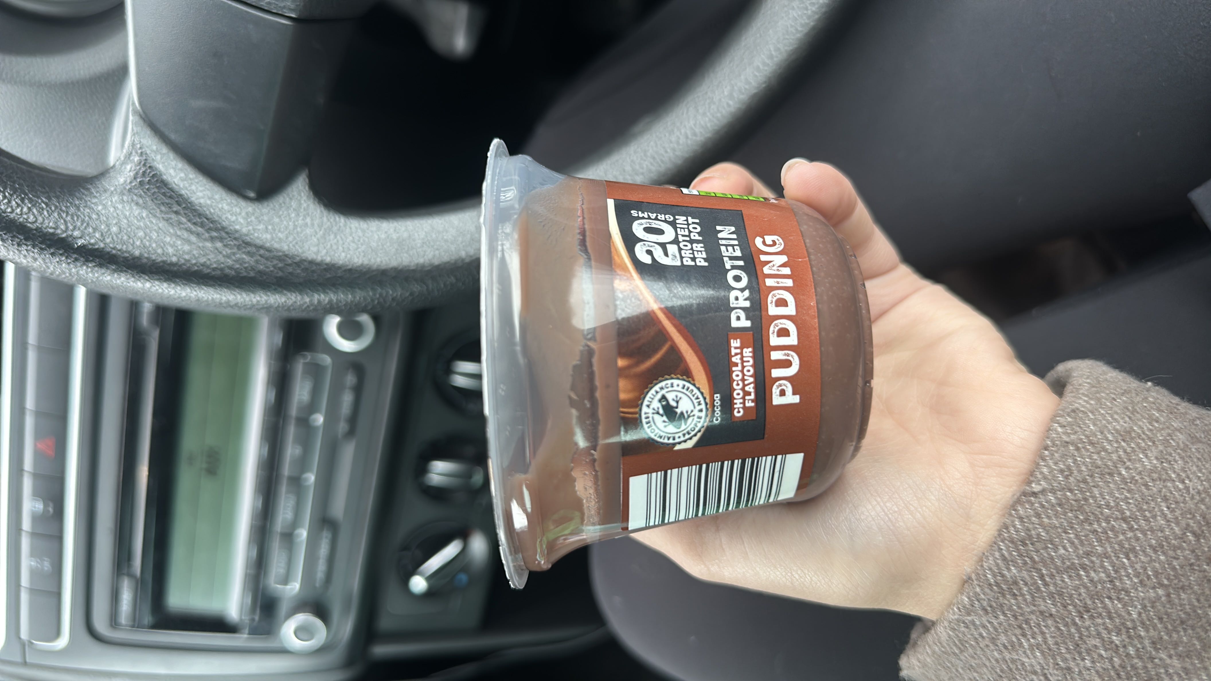 A chocolate-flavored protein pudding with 20 grams of protein per pot, designed as a nutritious snack.