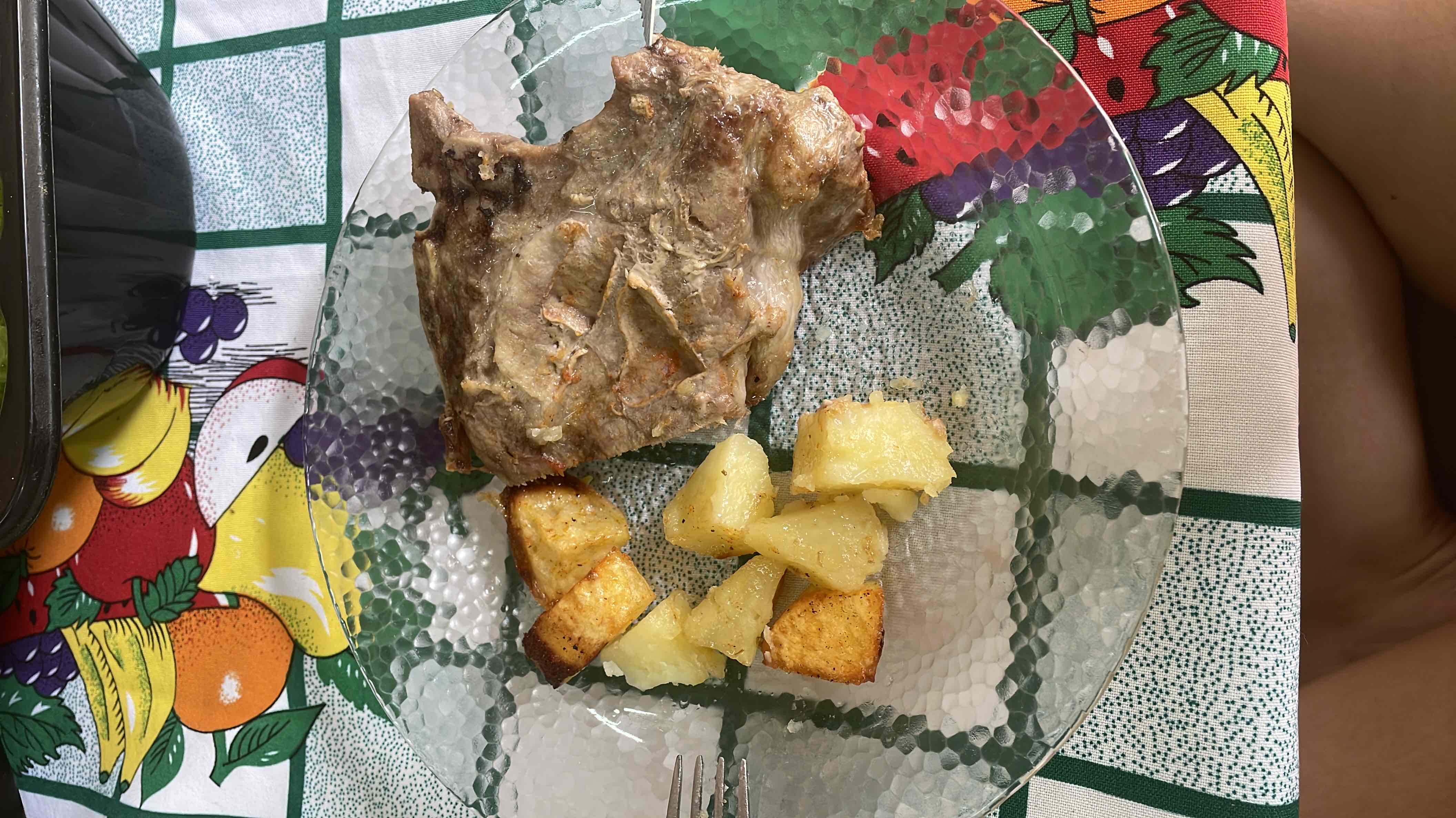 A plate containing grilled meat and roasted potatoes, providing a balanced mix of protein, carbs, and fats.