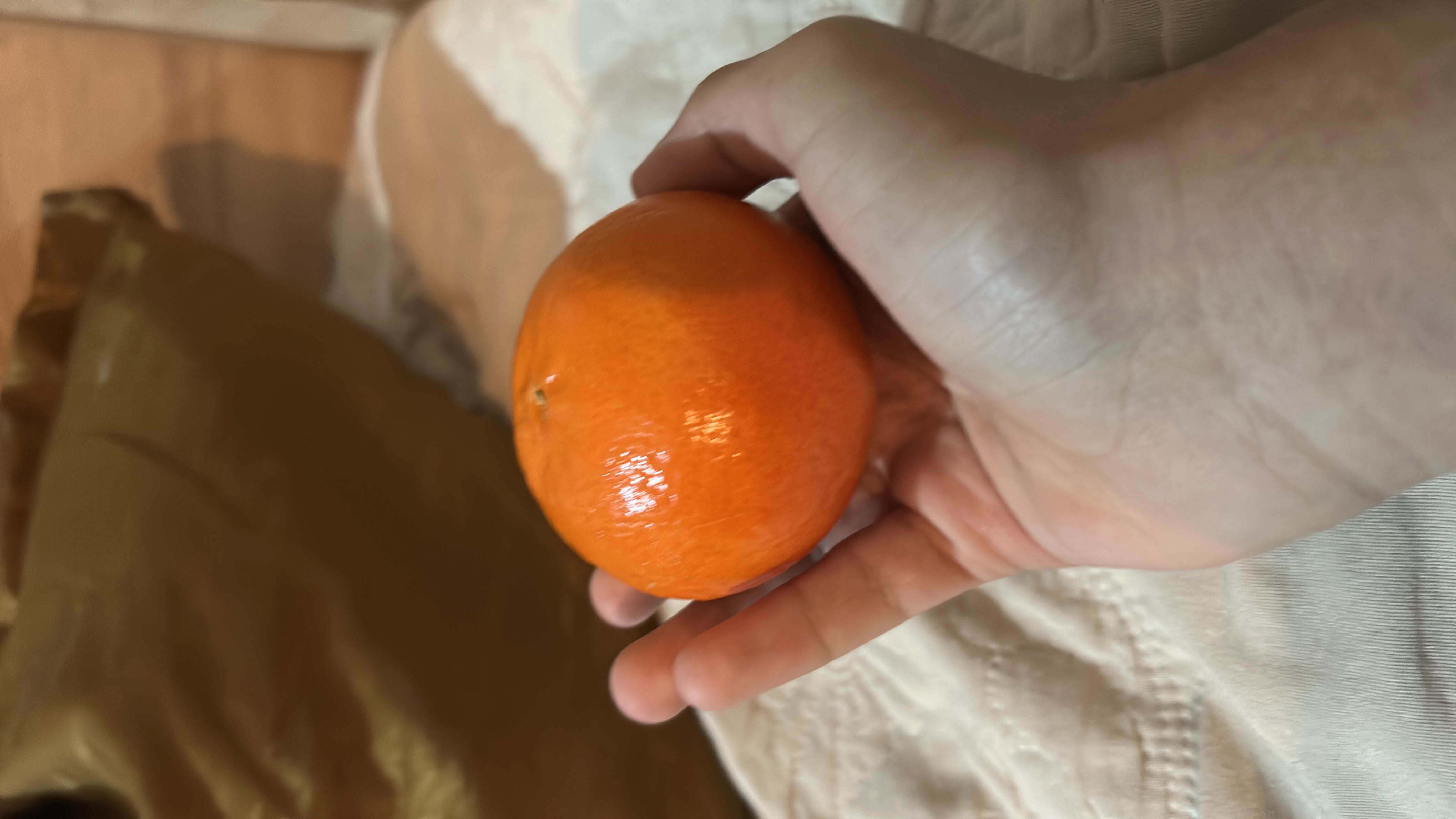 A fresh mandarin orange, a low-calorie fruit rich in vitamin C and dietary fiber.