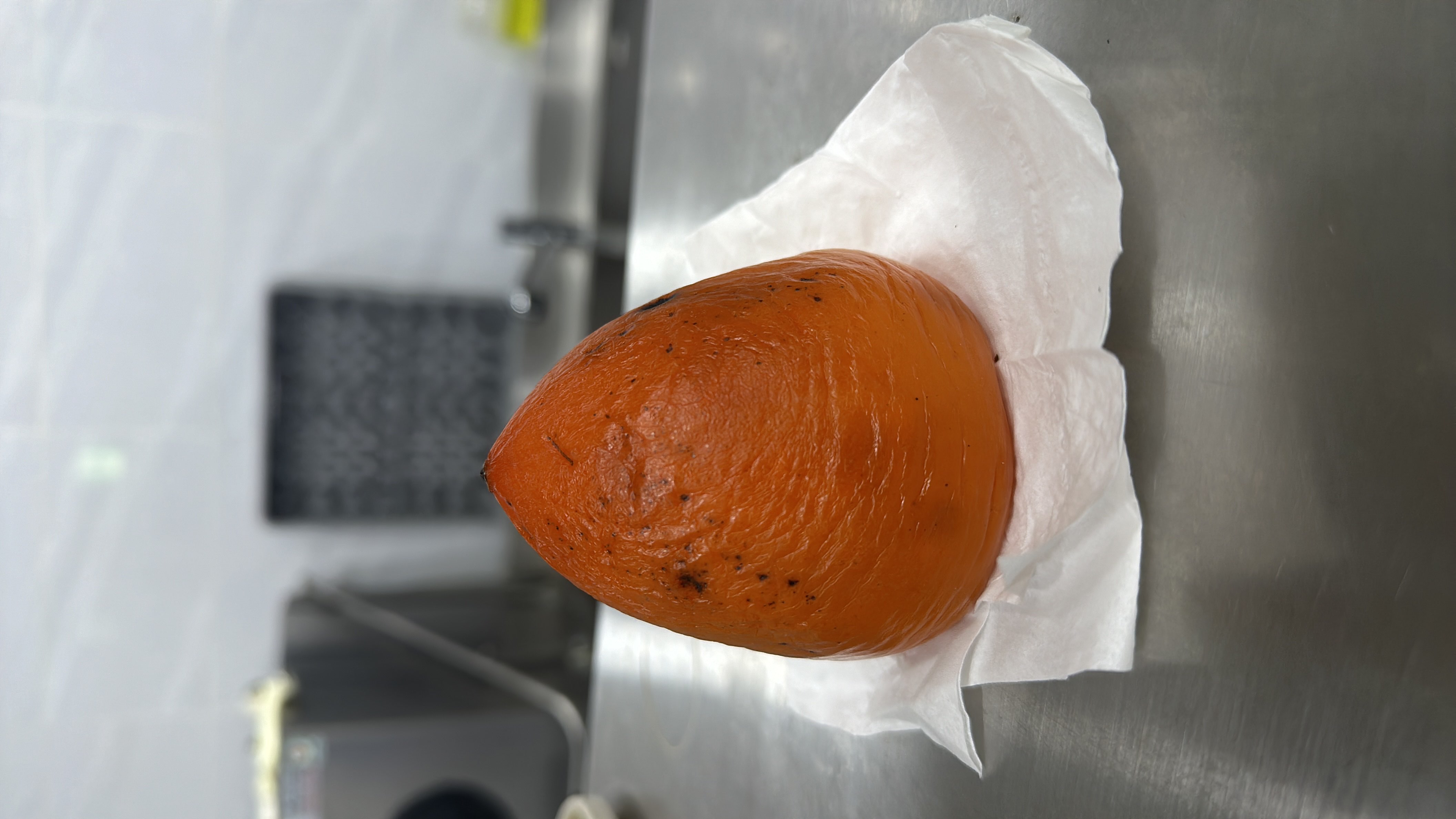 The image shows a roasted pumpkin, which is a low-fat, nutrient-rich food high in carbohydrates and fiber.