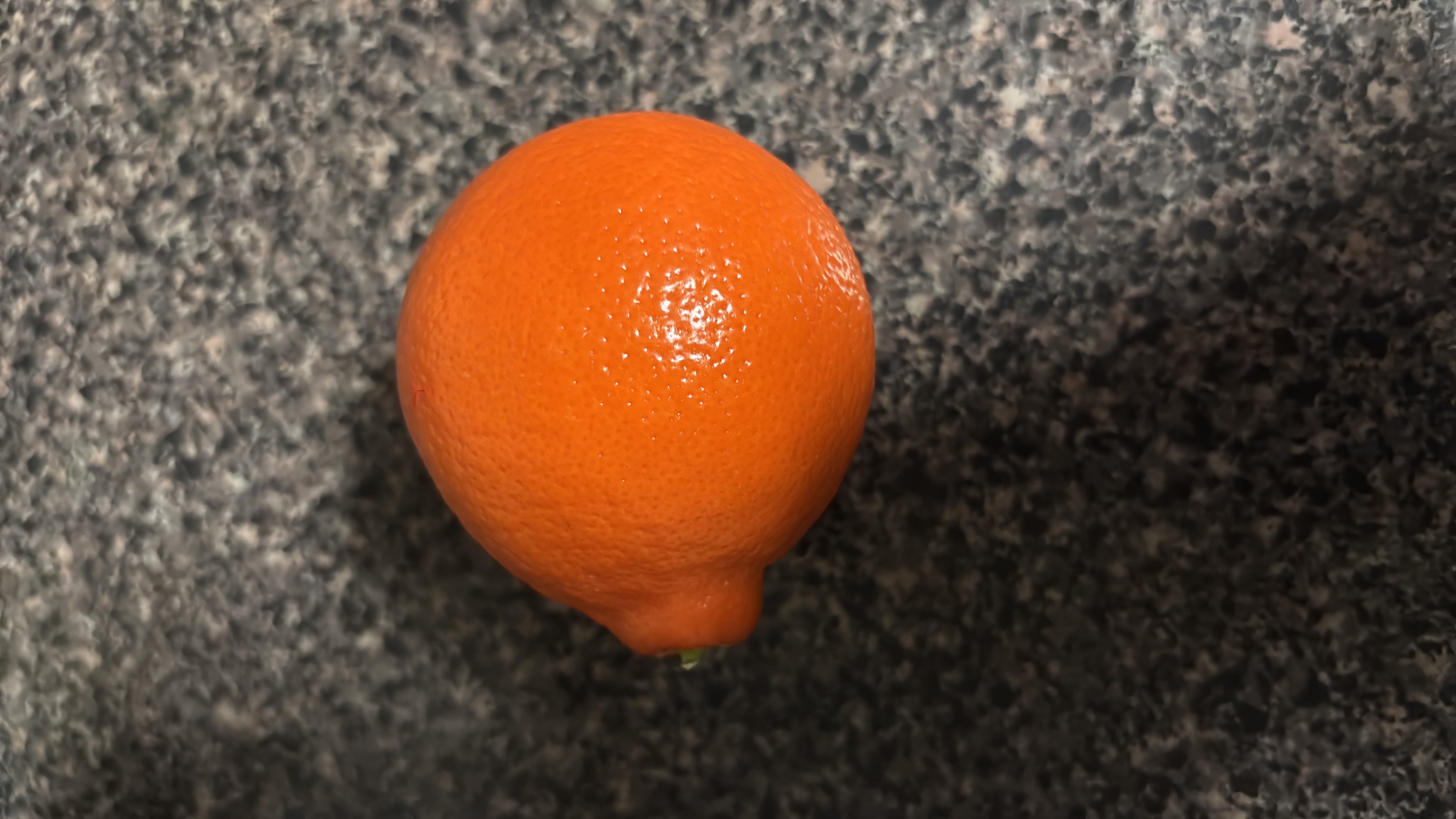 The image shows an orange, a citrus fruit that is low in calories and rich in vitamin C, making it a healthy snack option.