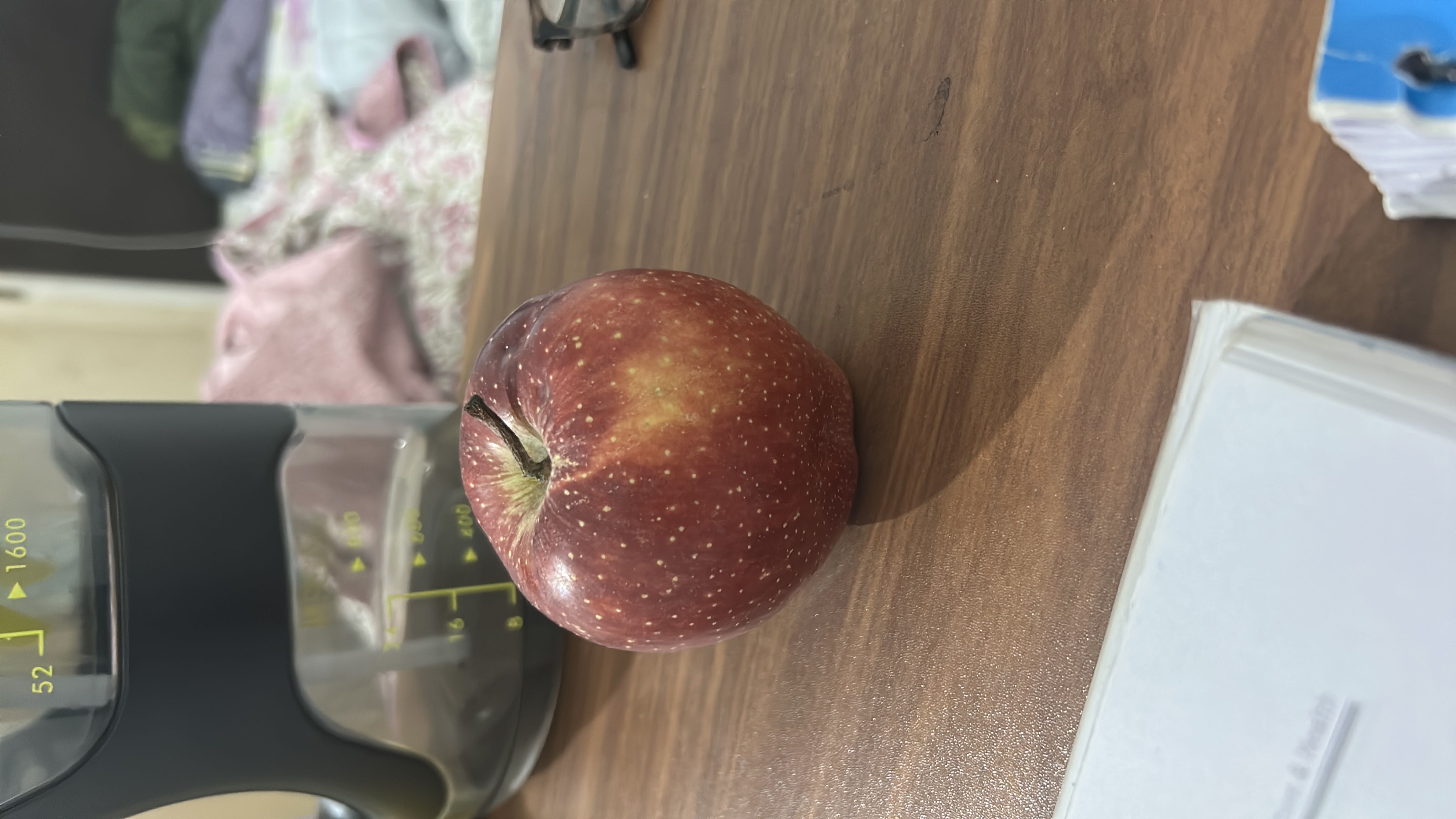 The image shows a fresh apple, which is a nutritious fruit rich in carbohydrates and low in fats and protein.