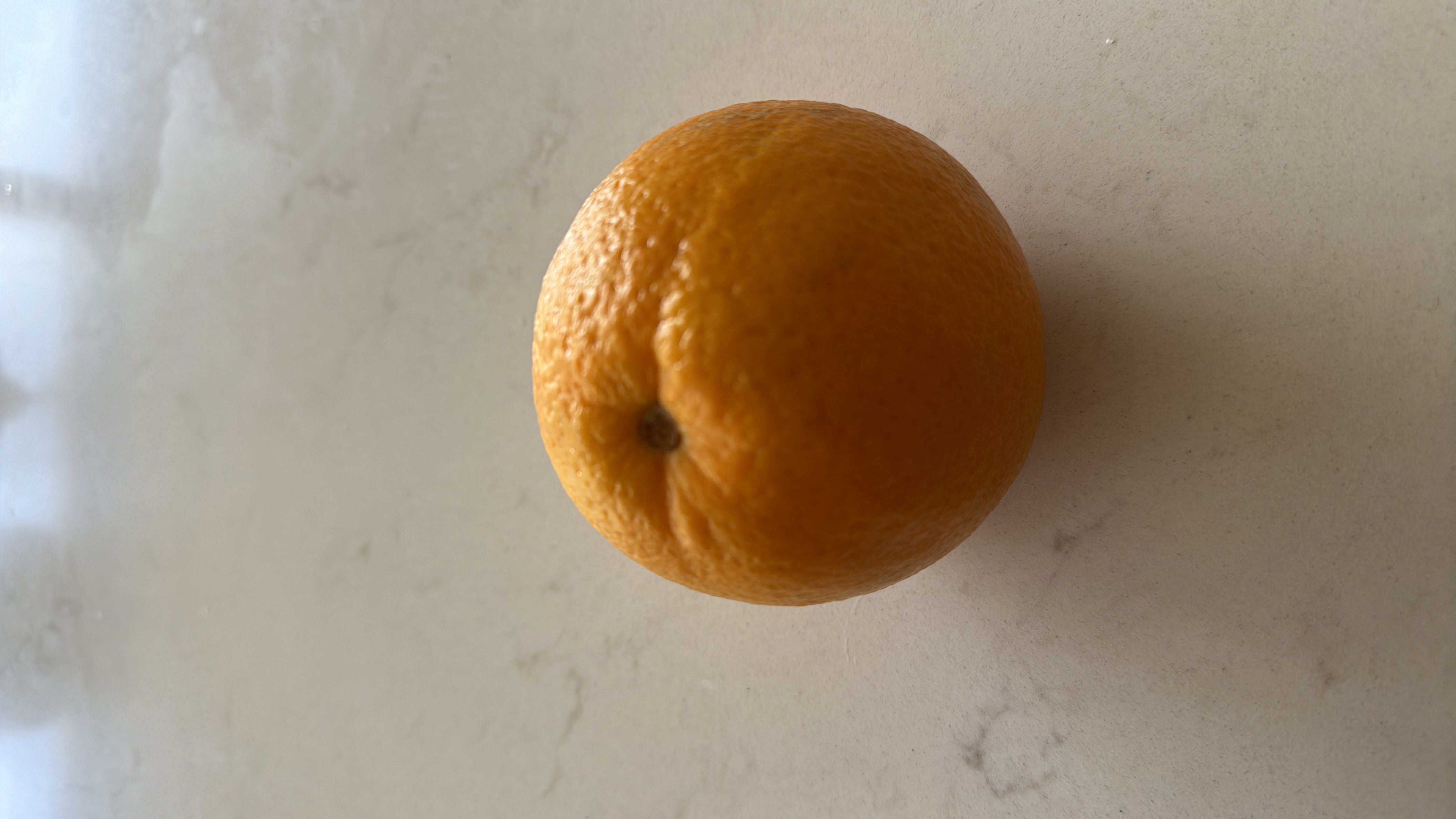 The image shows an orange, a citrus fruit rich in vitamin C, with moderate calories and high nutritional value.