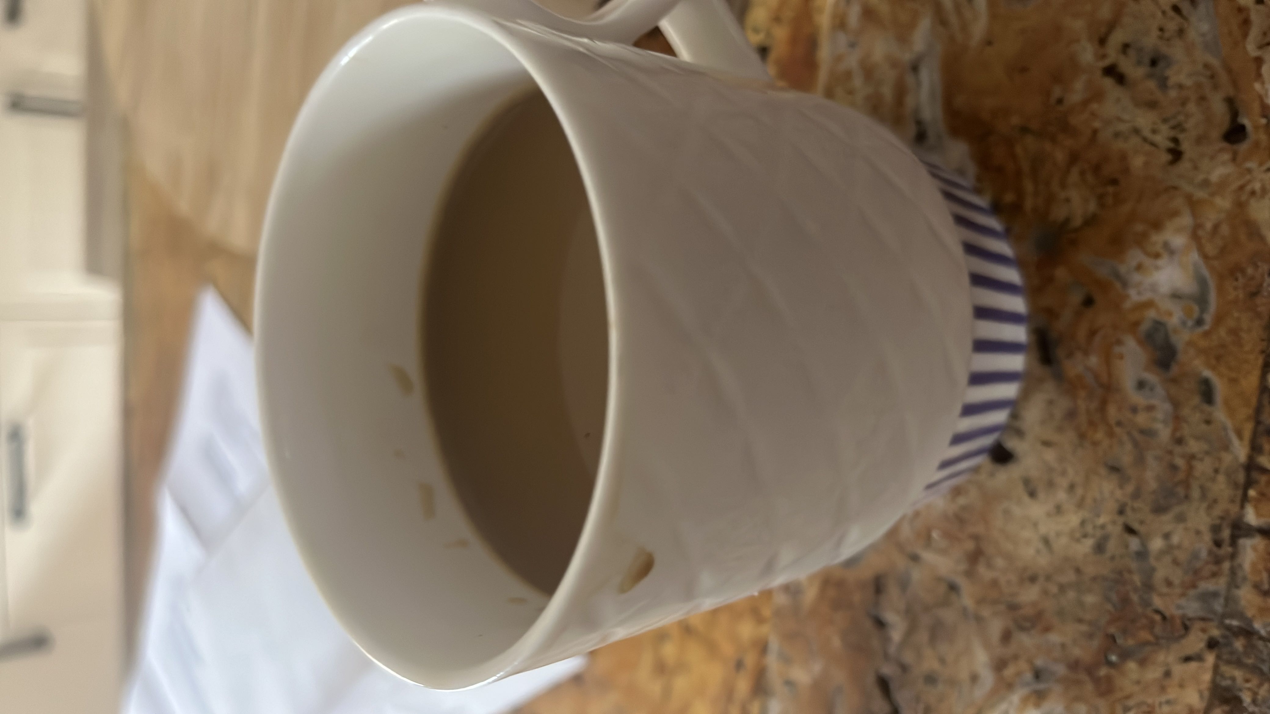 A cup of coffee with milk, providing moderate calories and a balanced nutritional profile.