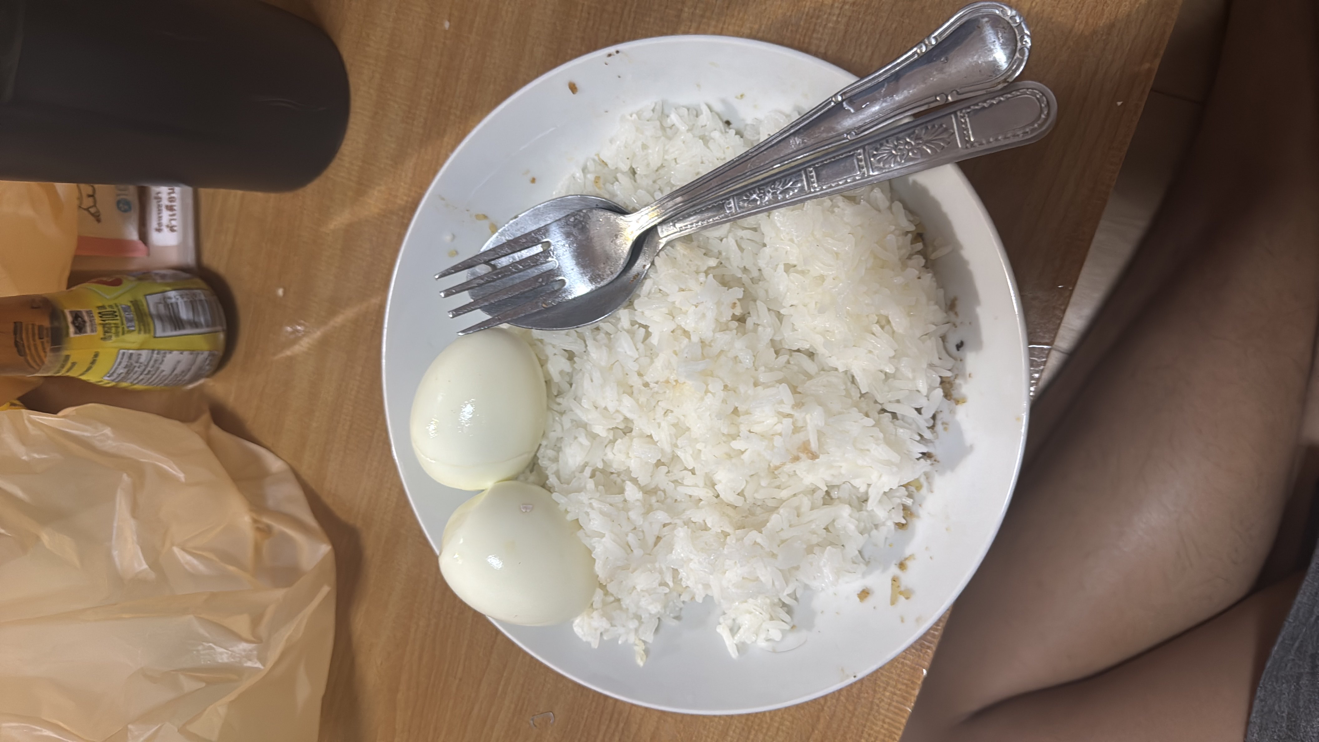 A simple meal consisting of white rice and two boiled eggs, providing a balance of carbohydrates and protein.