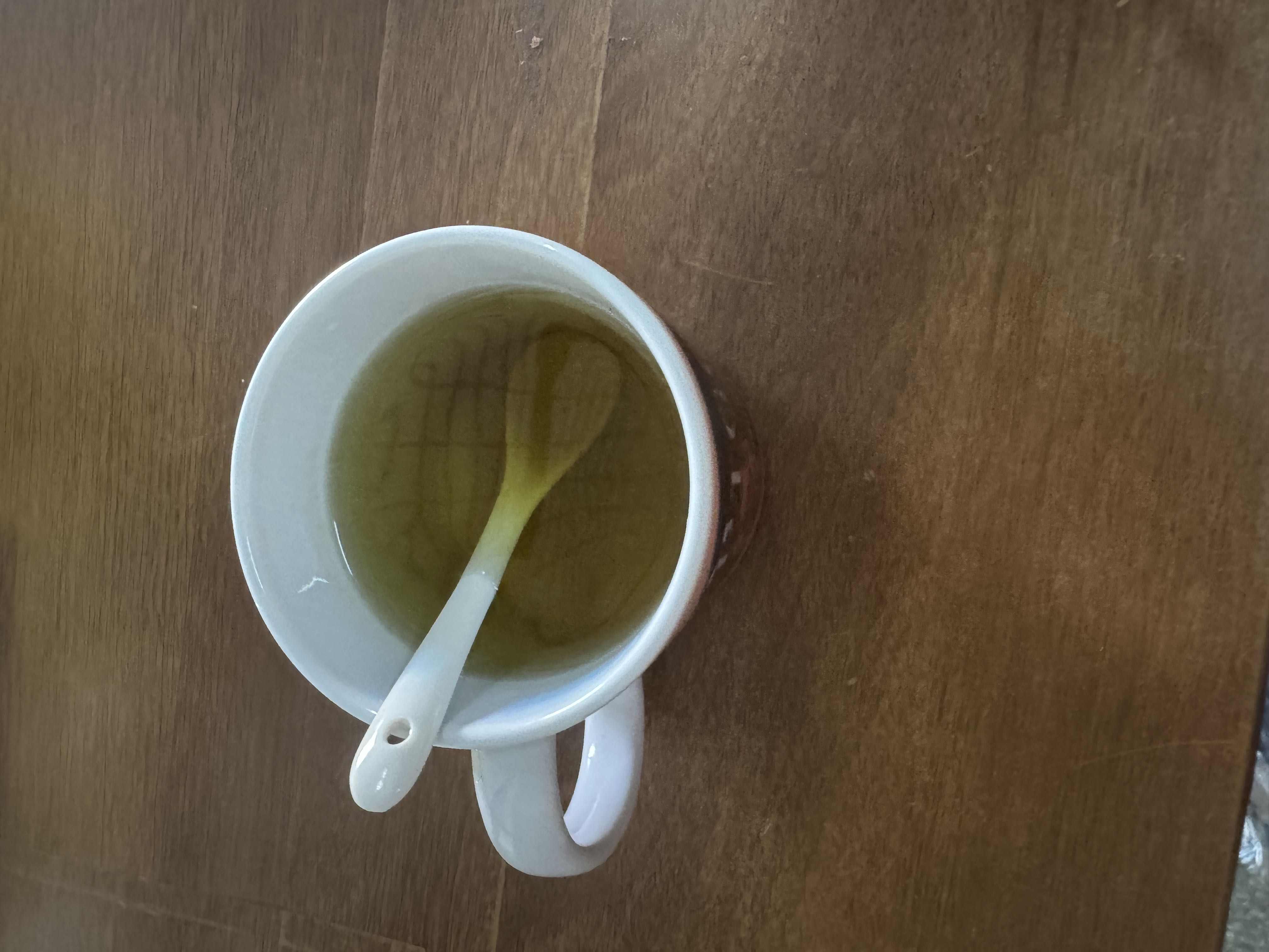 A cup of green tea, a low-calorie beverage with minimal macronutrients, known for its health benefits.