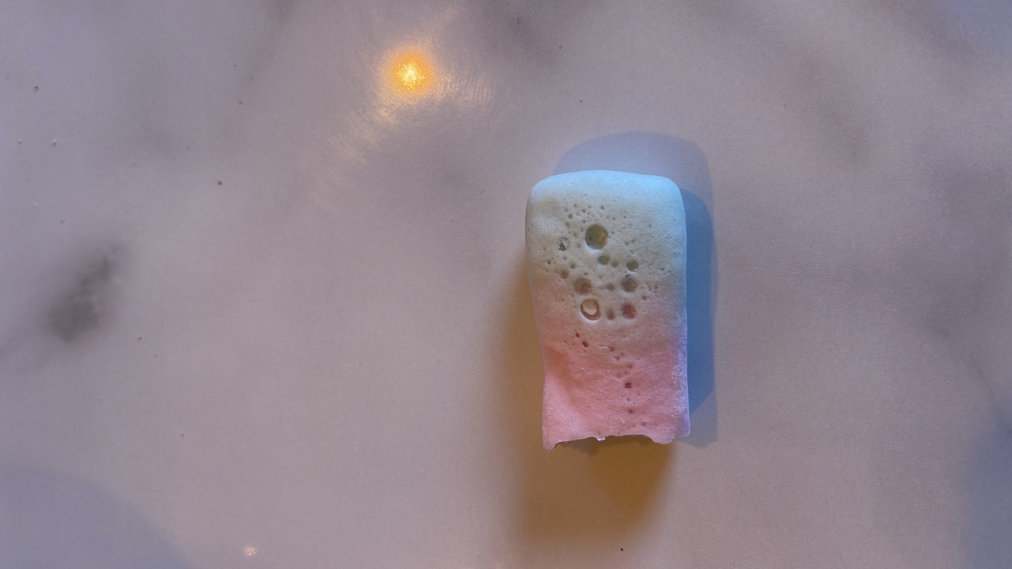 A partially eaten marshmallow, likely a sweet treat with moderate calories and low protein content.