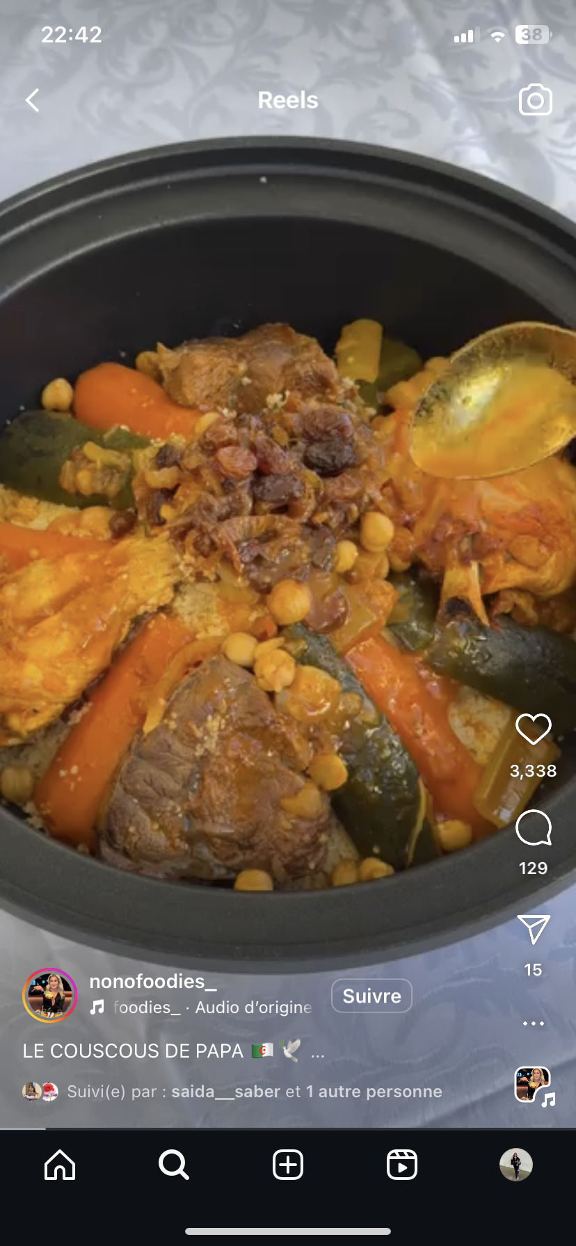 A traditional couscous dish with lamb, vegetables, and chickpeas, providing a balanced mix of protein, carbs, and fats.