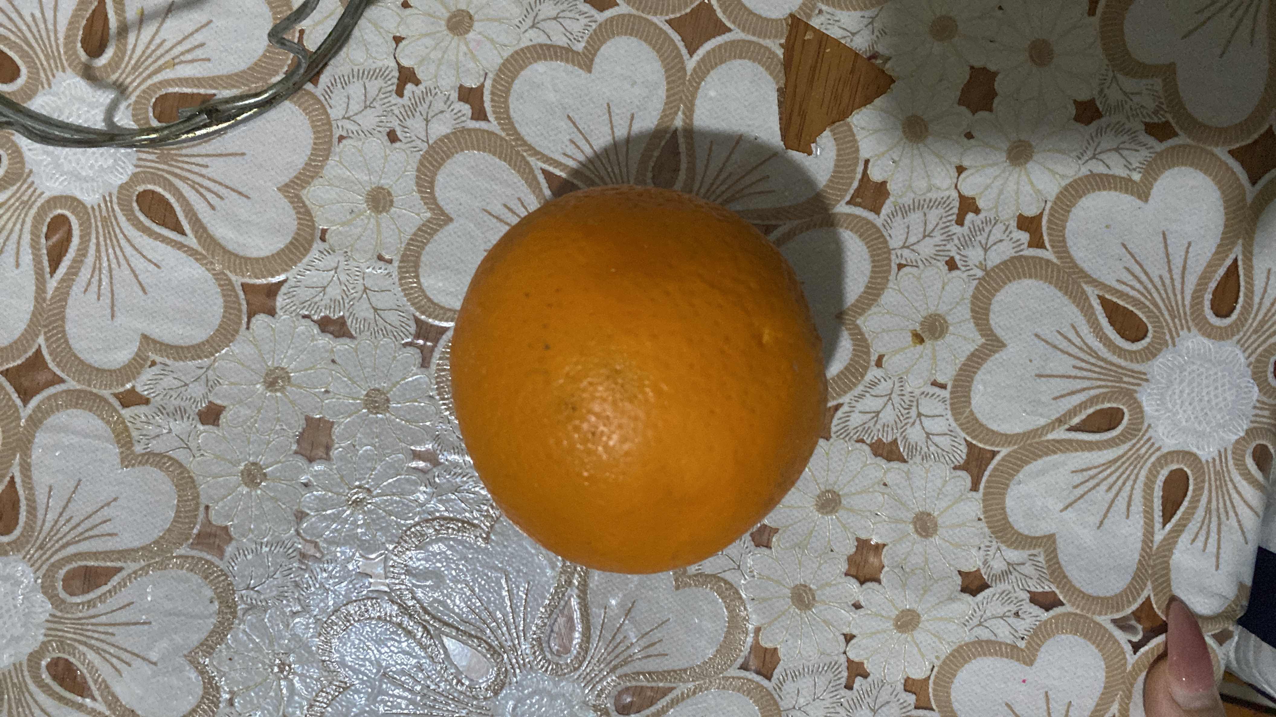 The image shows an orange, a citrus fruit rich in vitamin C, with moderate calories and high health benefits.