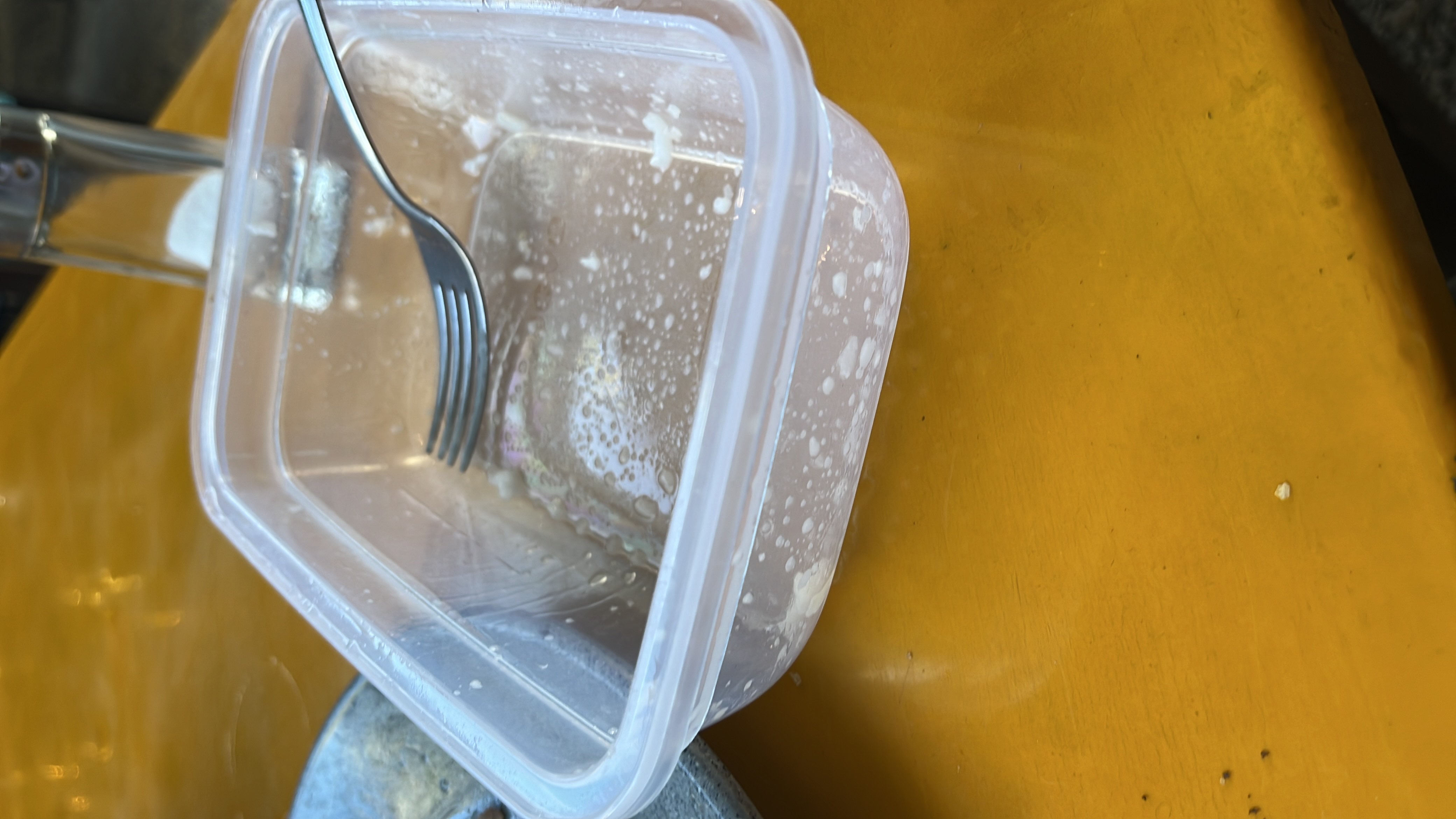 The image shows an empty food container with minimal food residue, indicating no significant nutritional content.