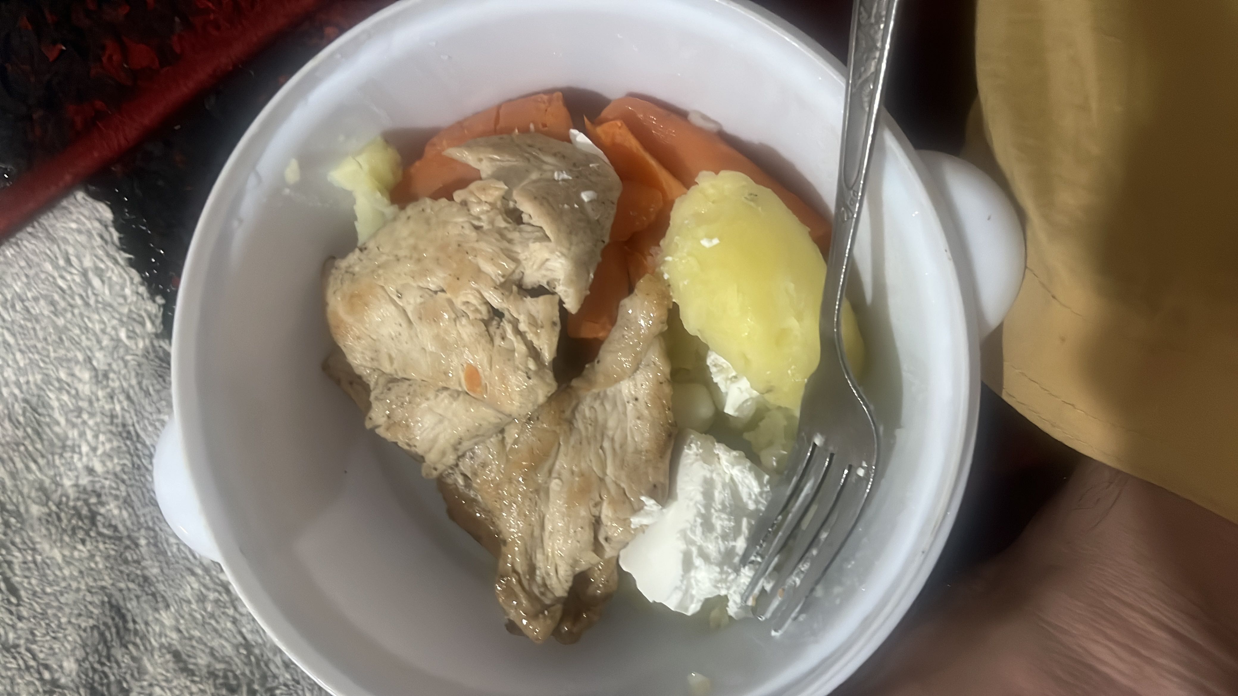 A balanced meal consisting of chicken breast, boiled potatoes, carrots, and cheese, providing a good mix of protein, carbs, and fats.