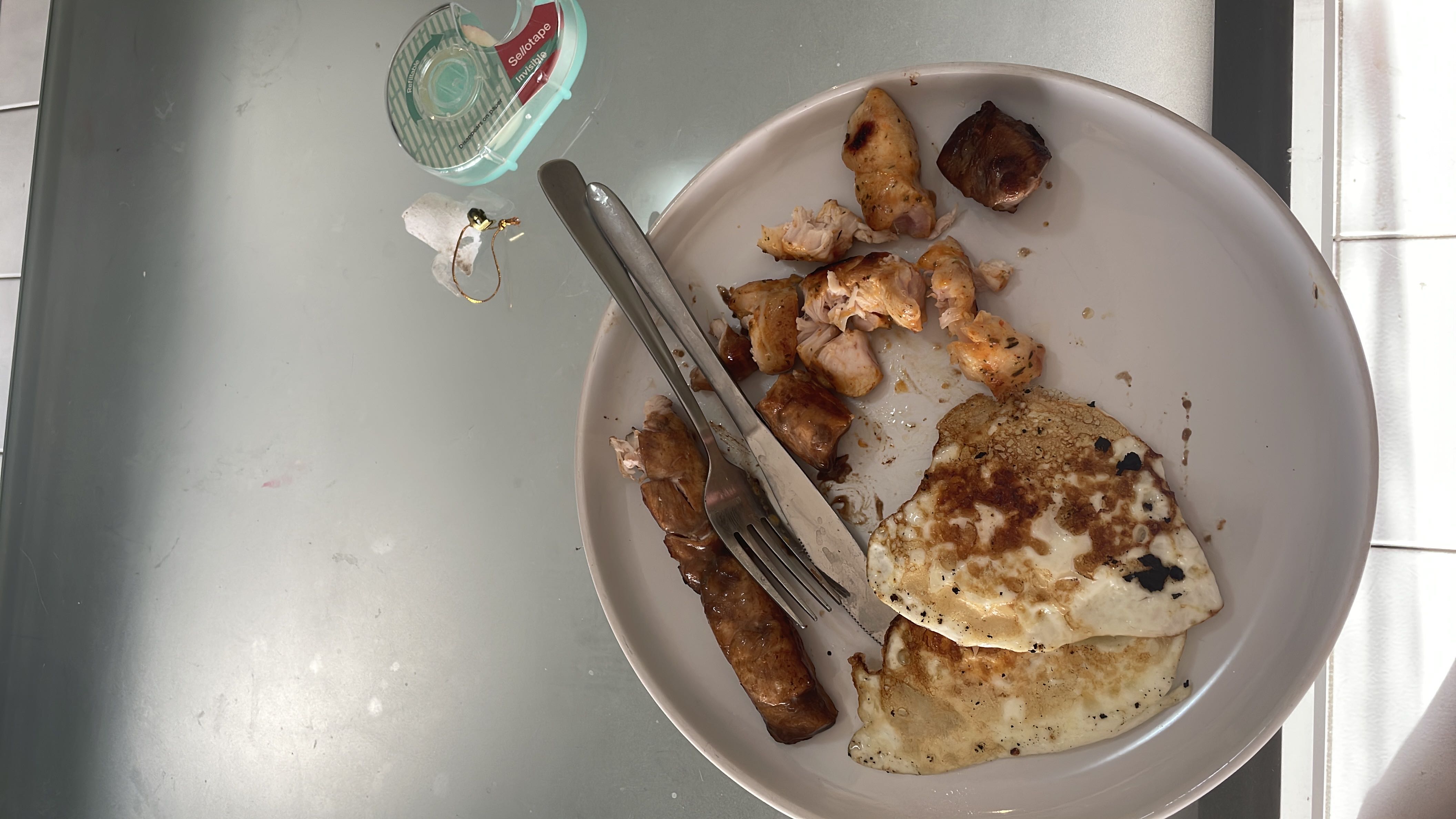 A protein-rich meal consisting of eggs, chicken, and sausage, with moderate fats and low carbohydrates.