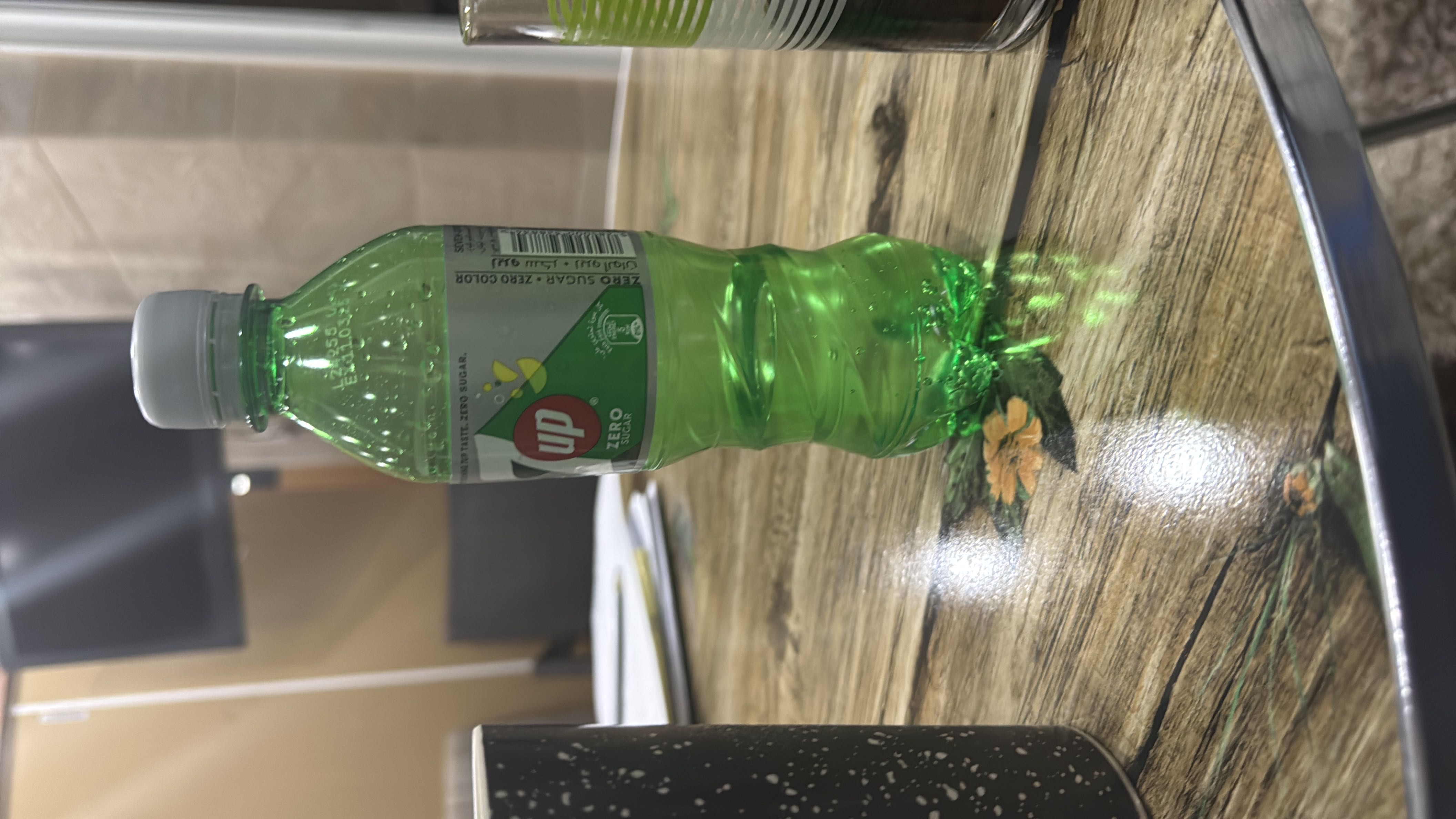 A bottle of 7UP Zero Sugar, a zero-calorie carbonated beverage with no fats, proteins, or carbohydrates.