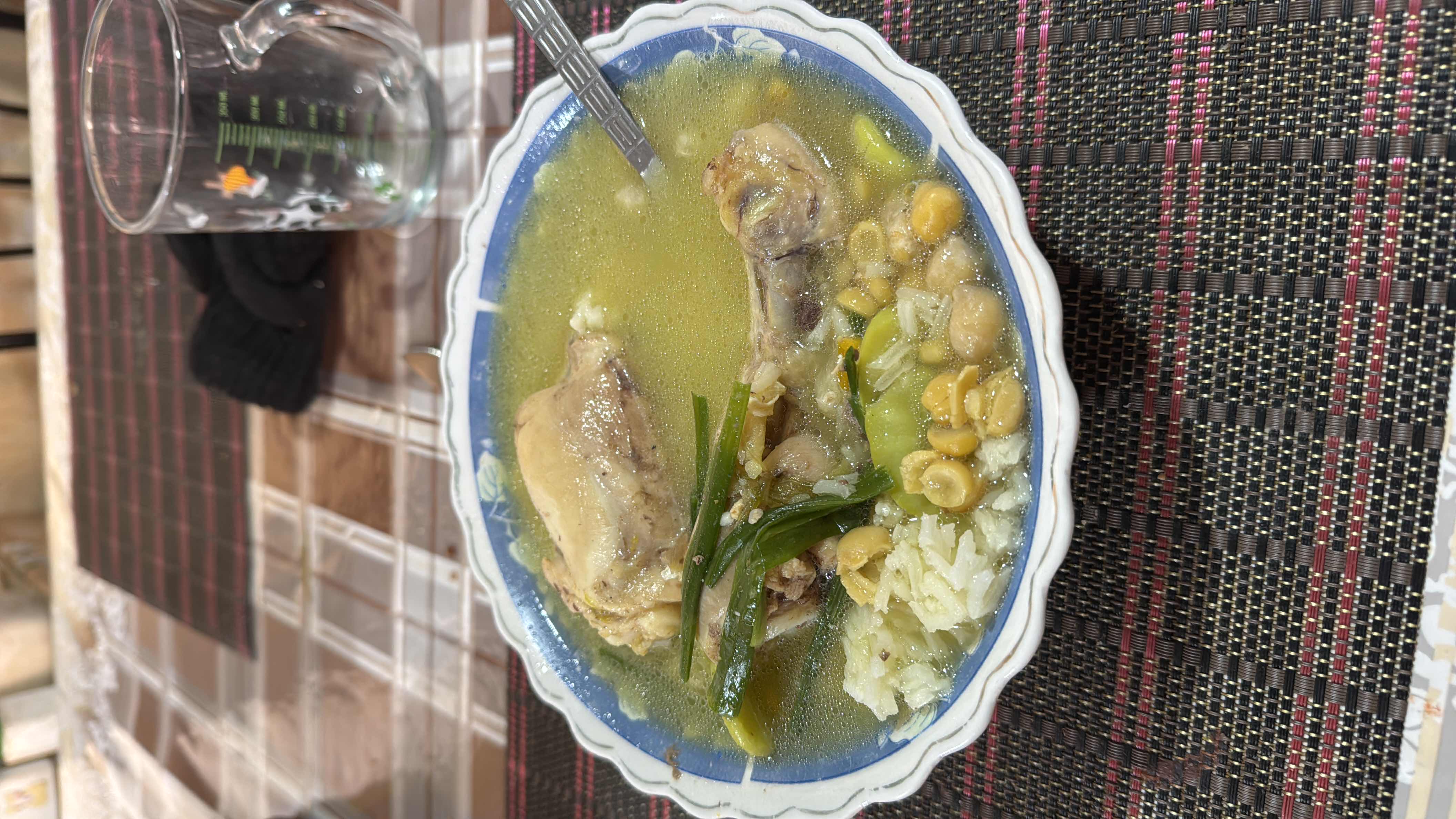 A nutritious chicken soup with rice, chickpeas, and vegetables, providing a balanced mix of protein, carbs, and fats.