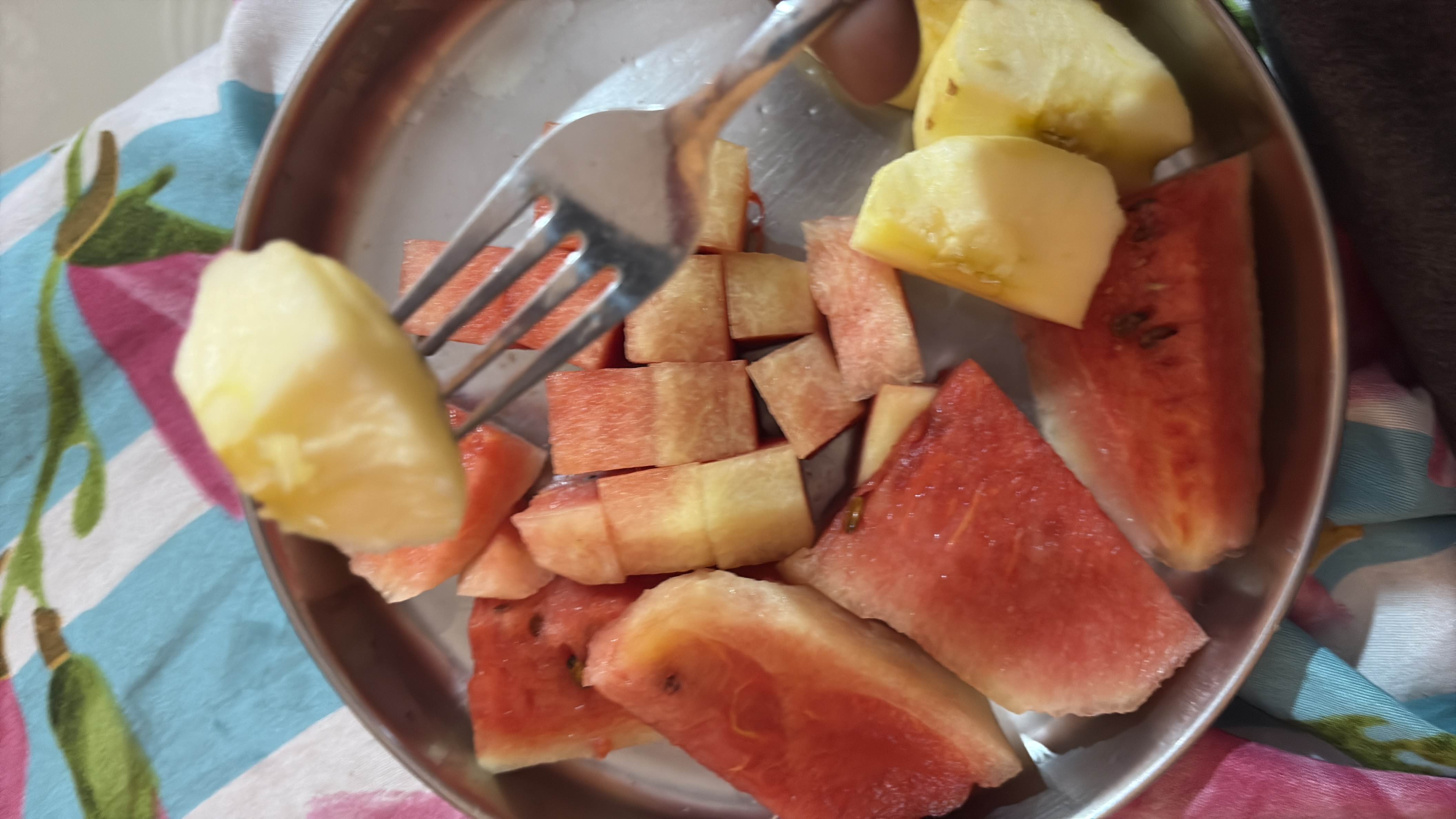 A plate containing fresh watermelon and apple slices, providing a low-calorie, nutrient-rich snack.