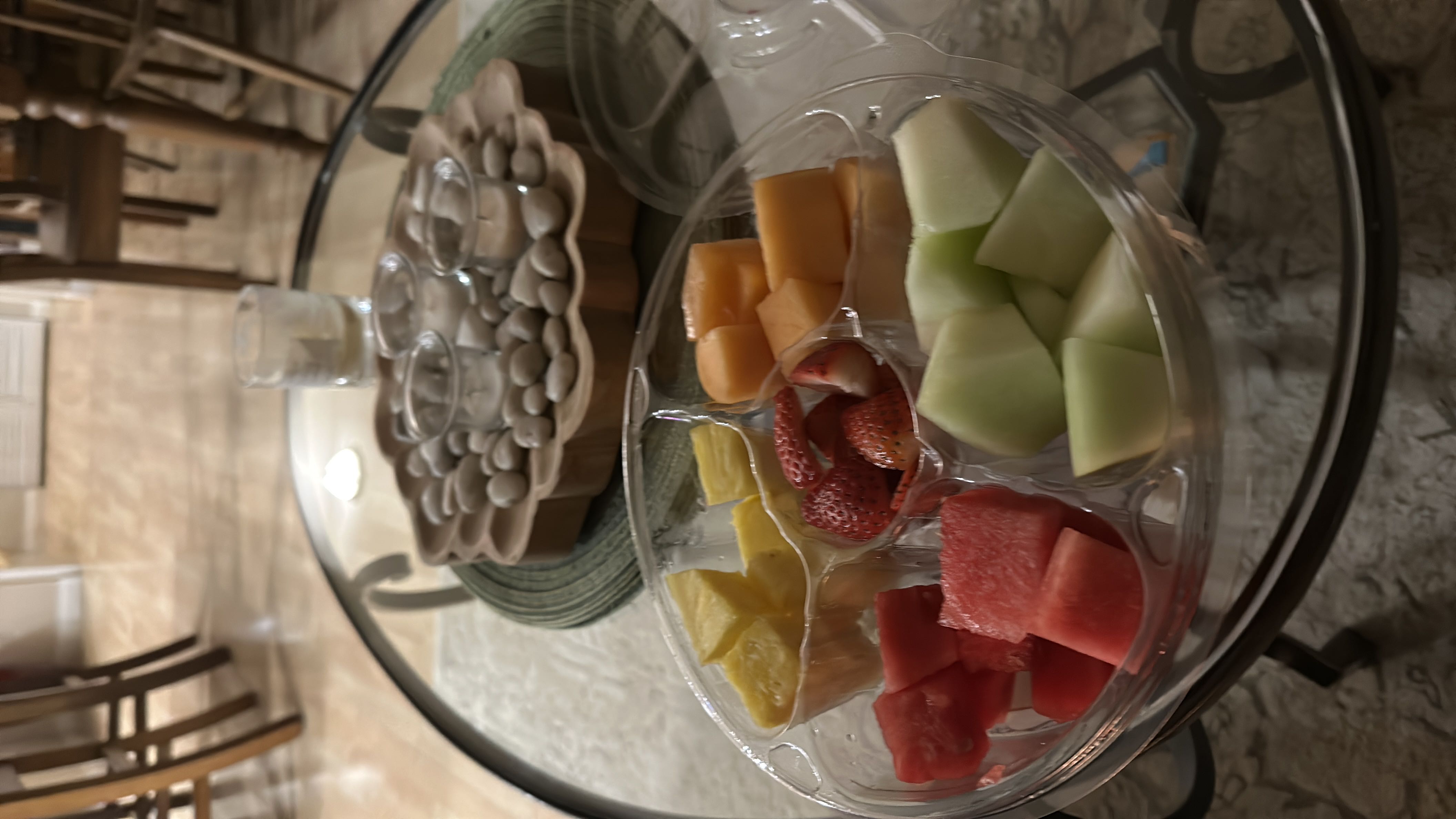 A fresh fruit platter containing pineapple, strawberries, cantaloupe, watermelon, and honeydew, offering a low-calorie, nutrient-rich snack.