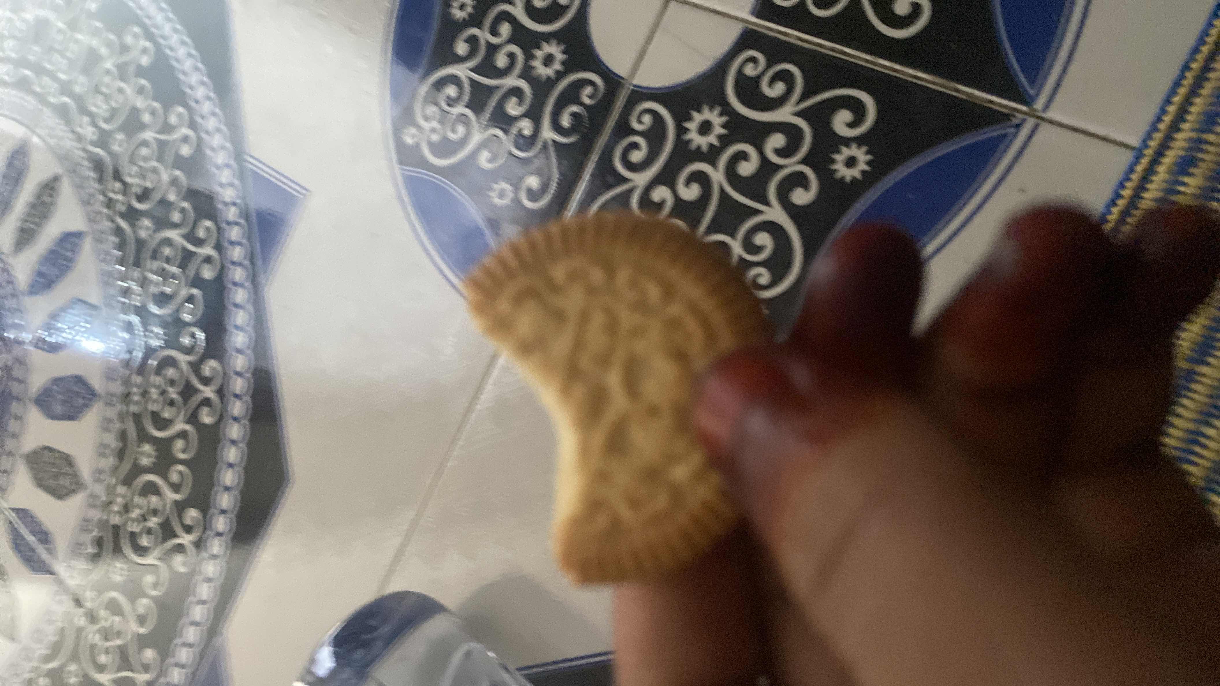 A partially eaten cookie, likely a sweet snack with moderate calories and low protein content.