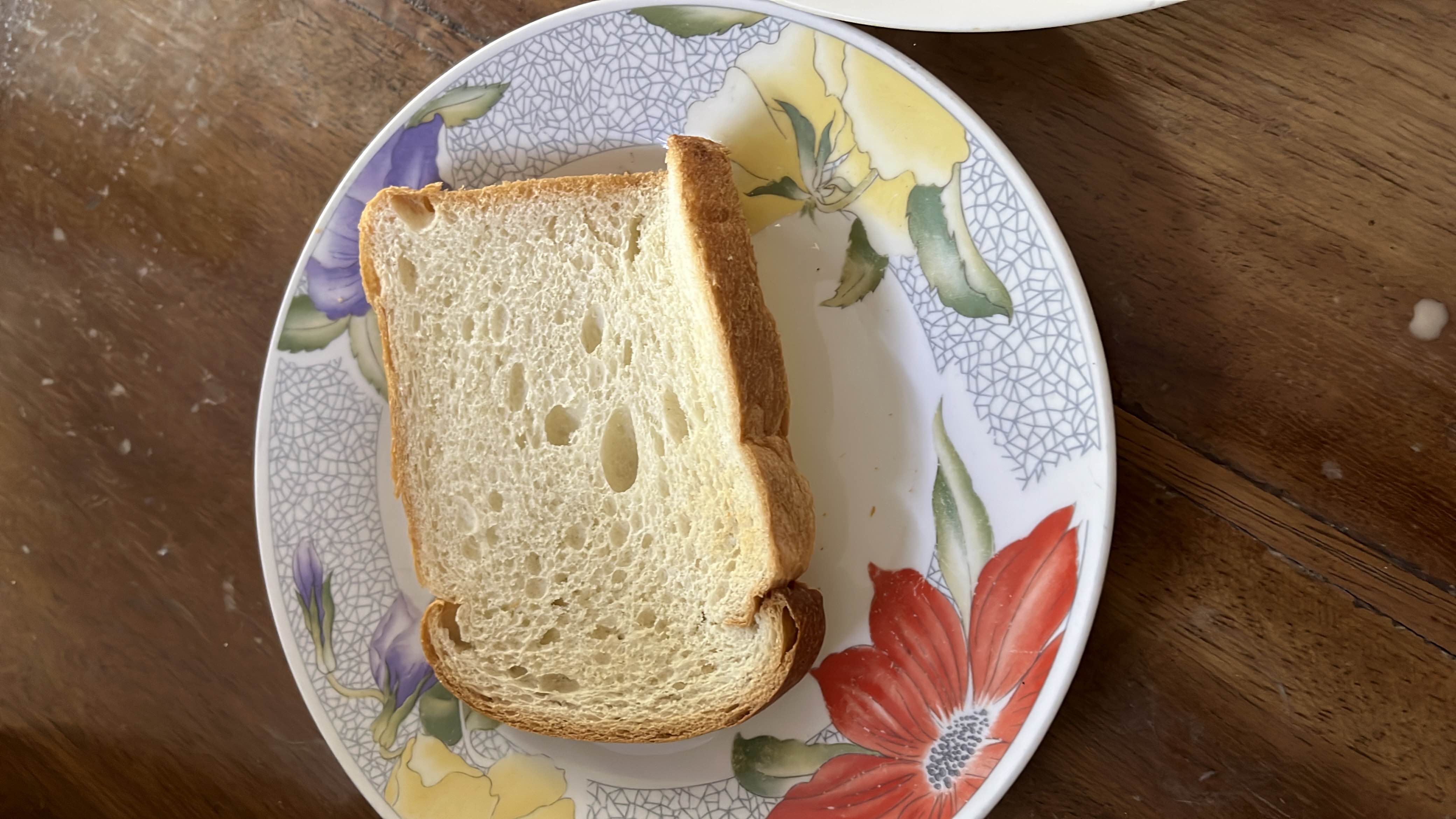 A single slice of bread, typically a source of carbohydrates with minimal protein and fat content.