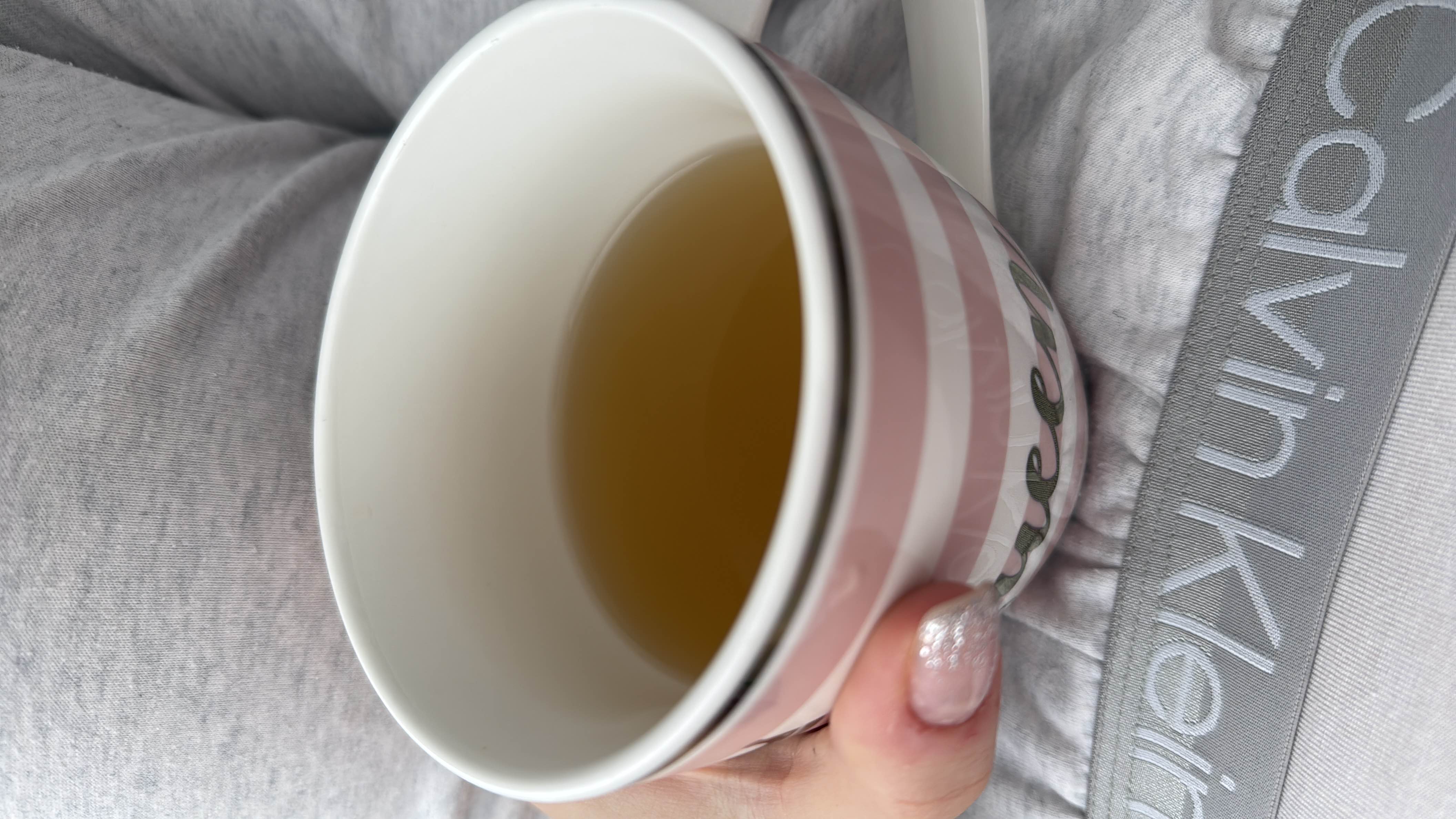 A cup of green tea, a low-calorie beverage with minimal nutritional content, known for its health benefits.