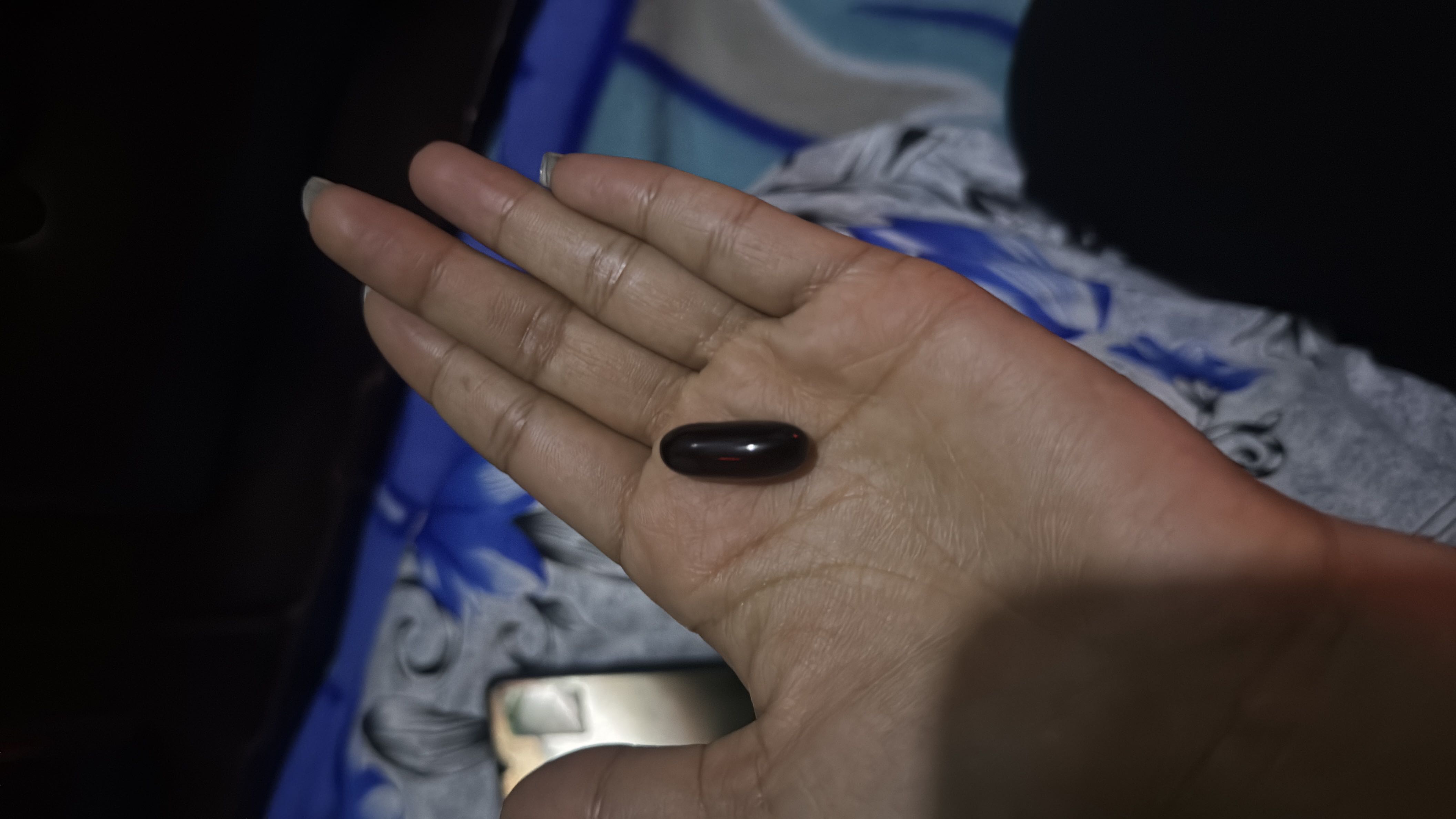 The image shows a softgel capsule, likely a dietary supplement or vitamin, with negligible nutritional content.