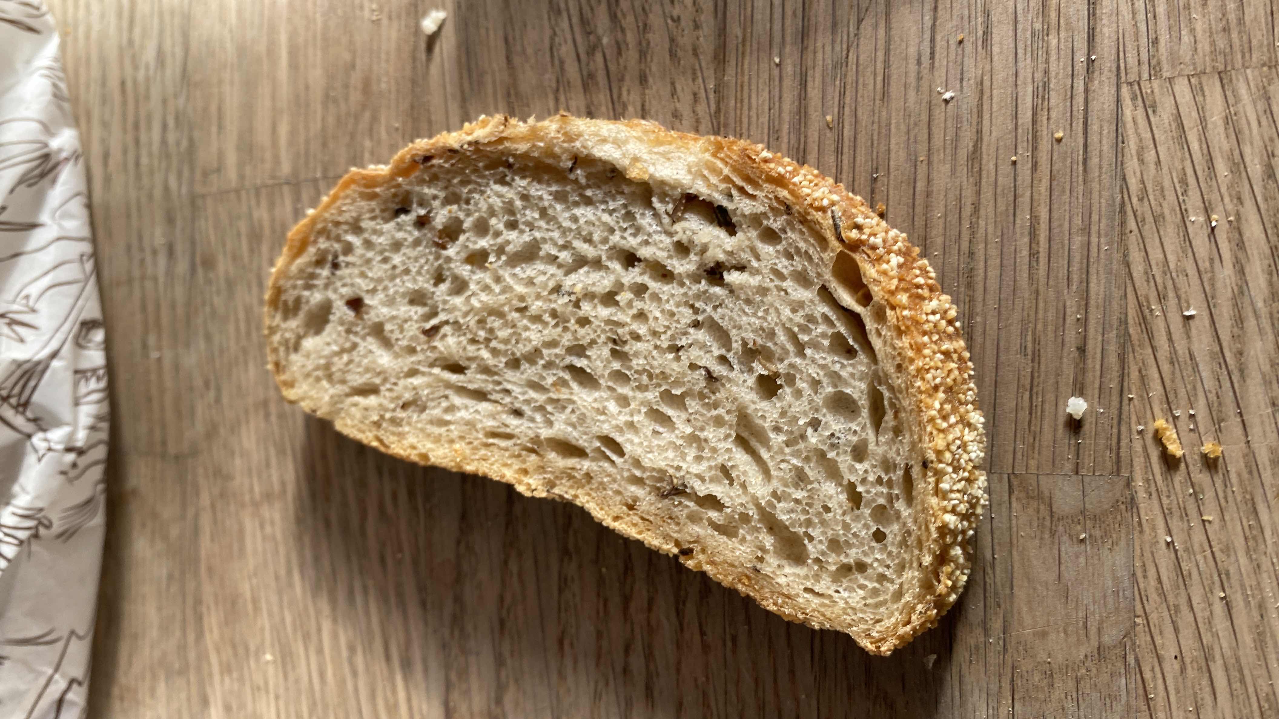 A single slice of sesame-seeded bread, likely whole grain, providing moderate calories and nutrients.