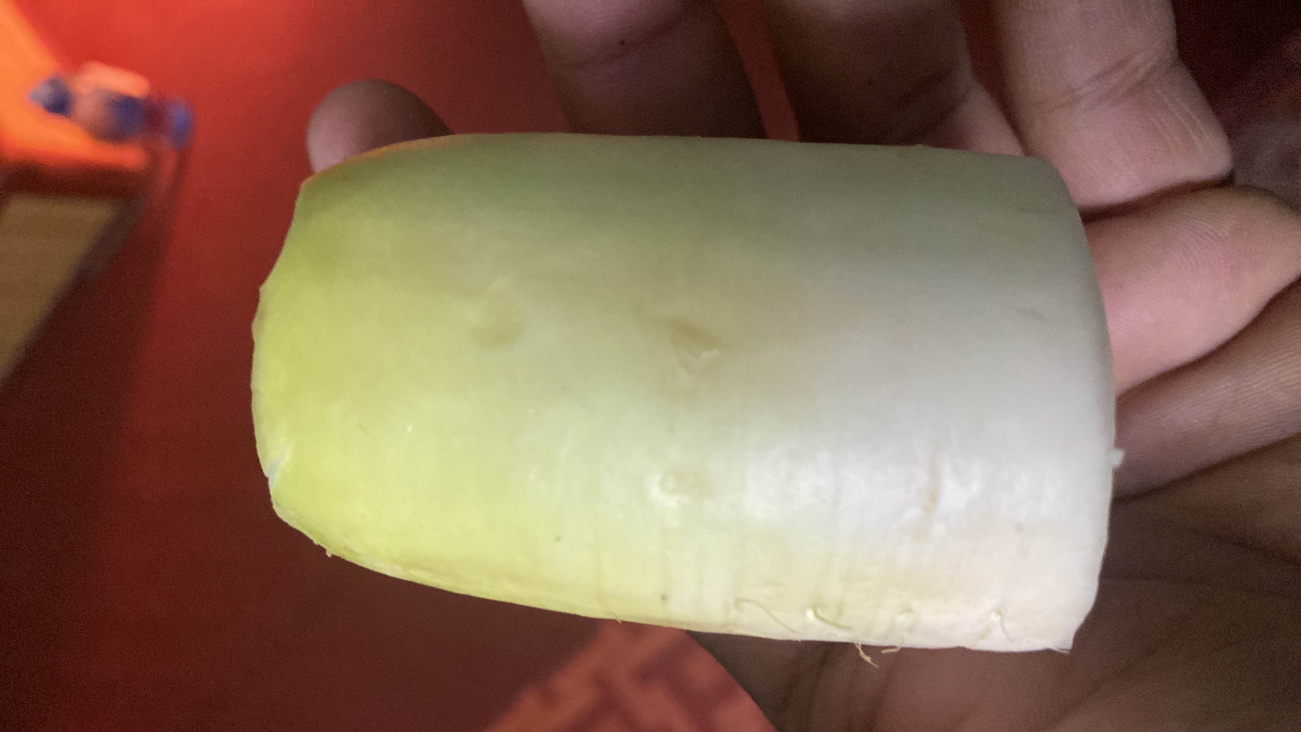 The image shows a piece of radish, a low-calorie root vegetable rich in nutrients and commonly used in salads and dishes.