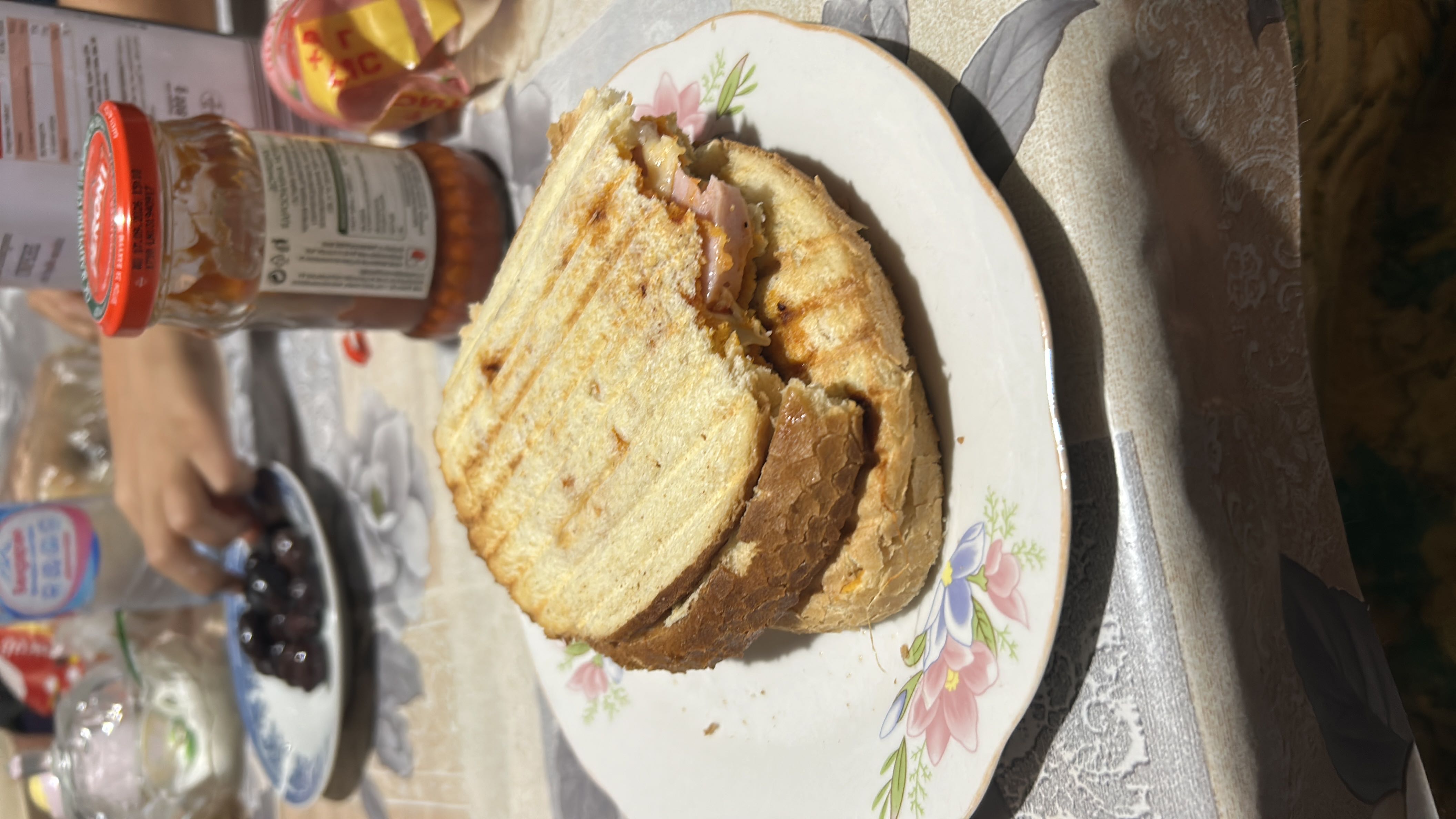 A grilled sandwich made with bread, ham, and cheese, providing a balanced mix of protein, carbs, and fats.