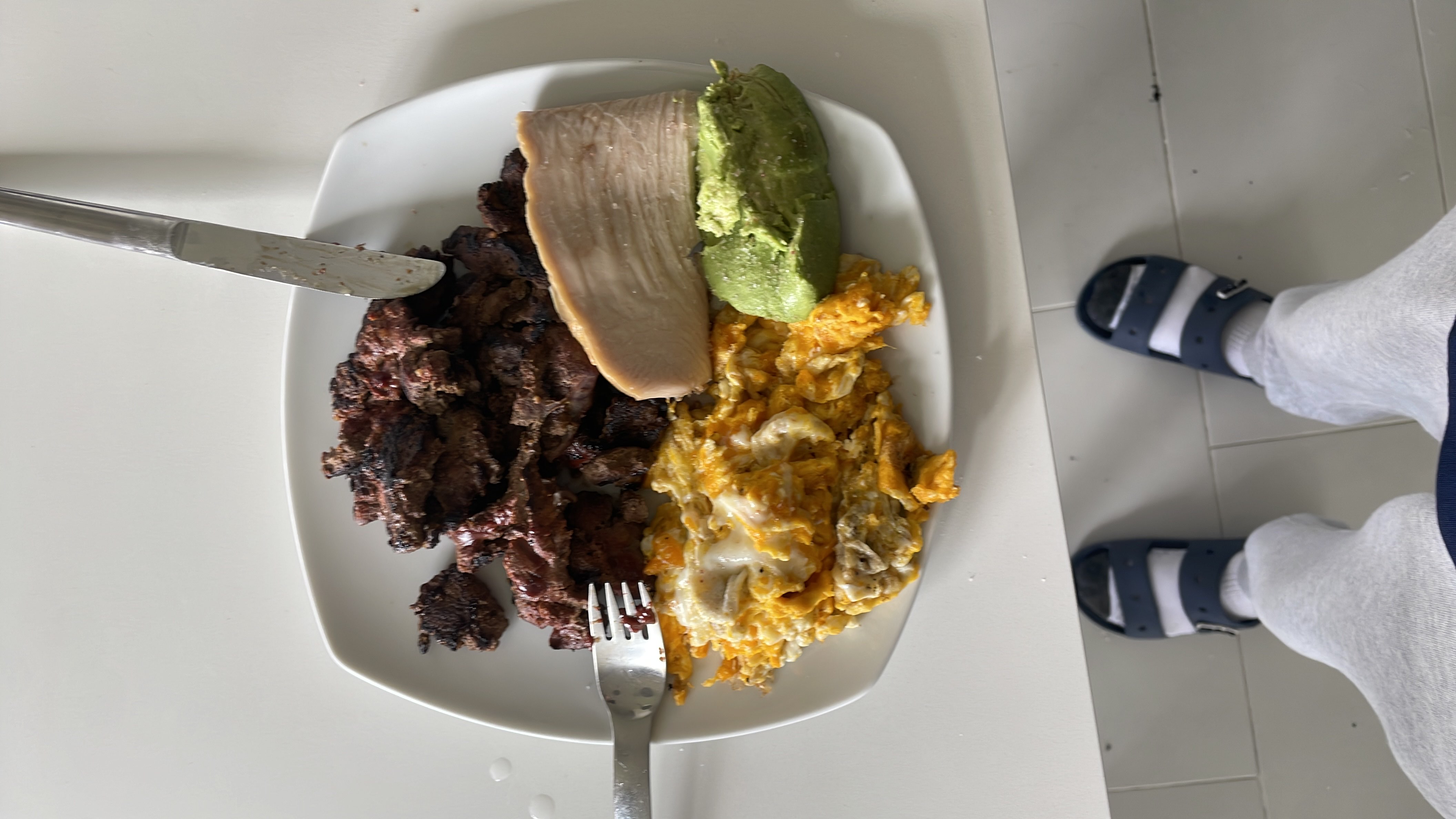 A high-protein meal consisting of beef liver, scrambled eggs with cheese using 4 eggs, and avocado.