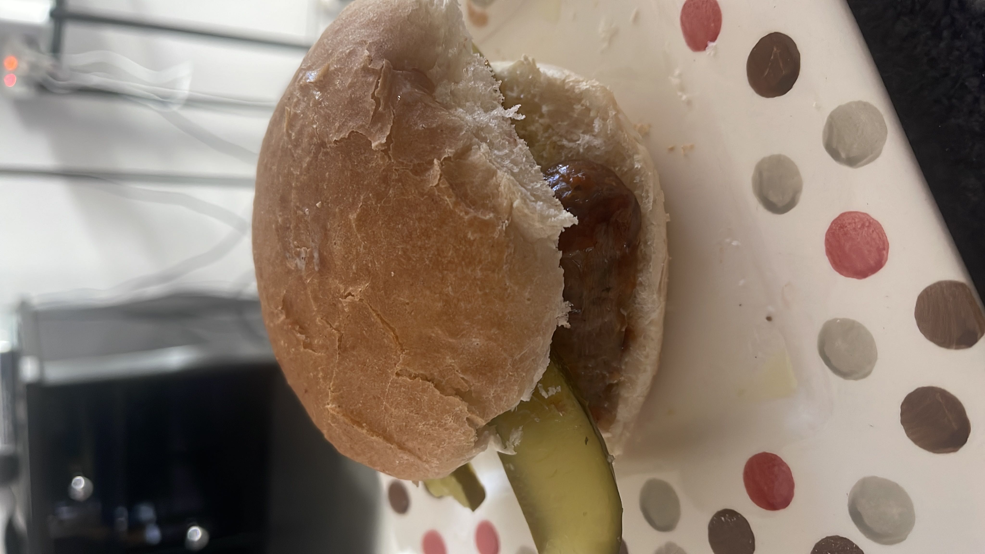 A sandwich consisting of a bread bun, a meat patty, and a pickle slice, providing a balanced mix of protein, carbs, and fats.