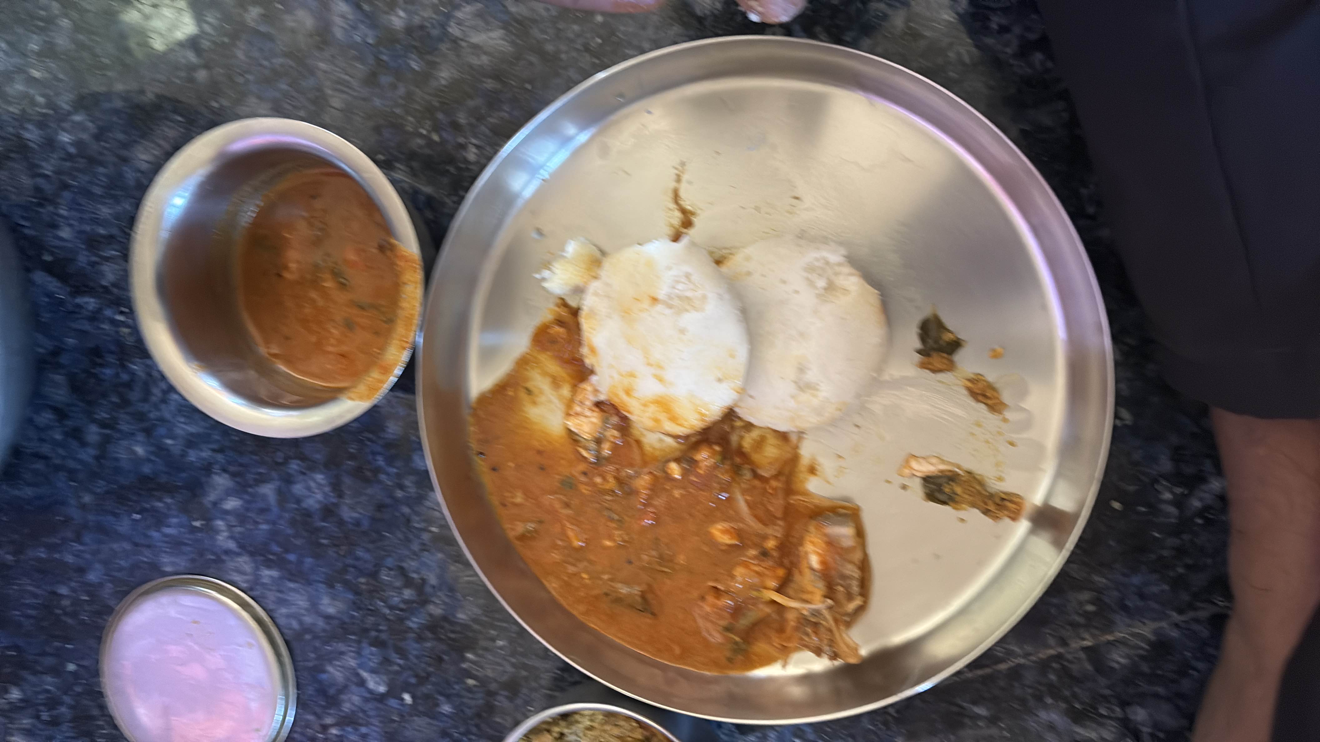 A South Indian dish consisting of steamed rice cakes (idli) served with a fish-based curry.