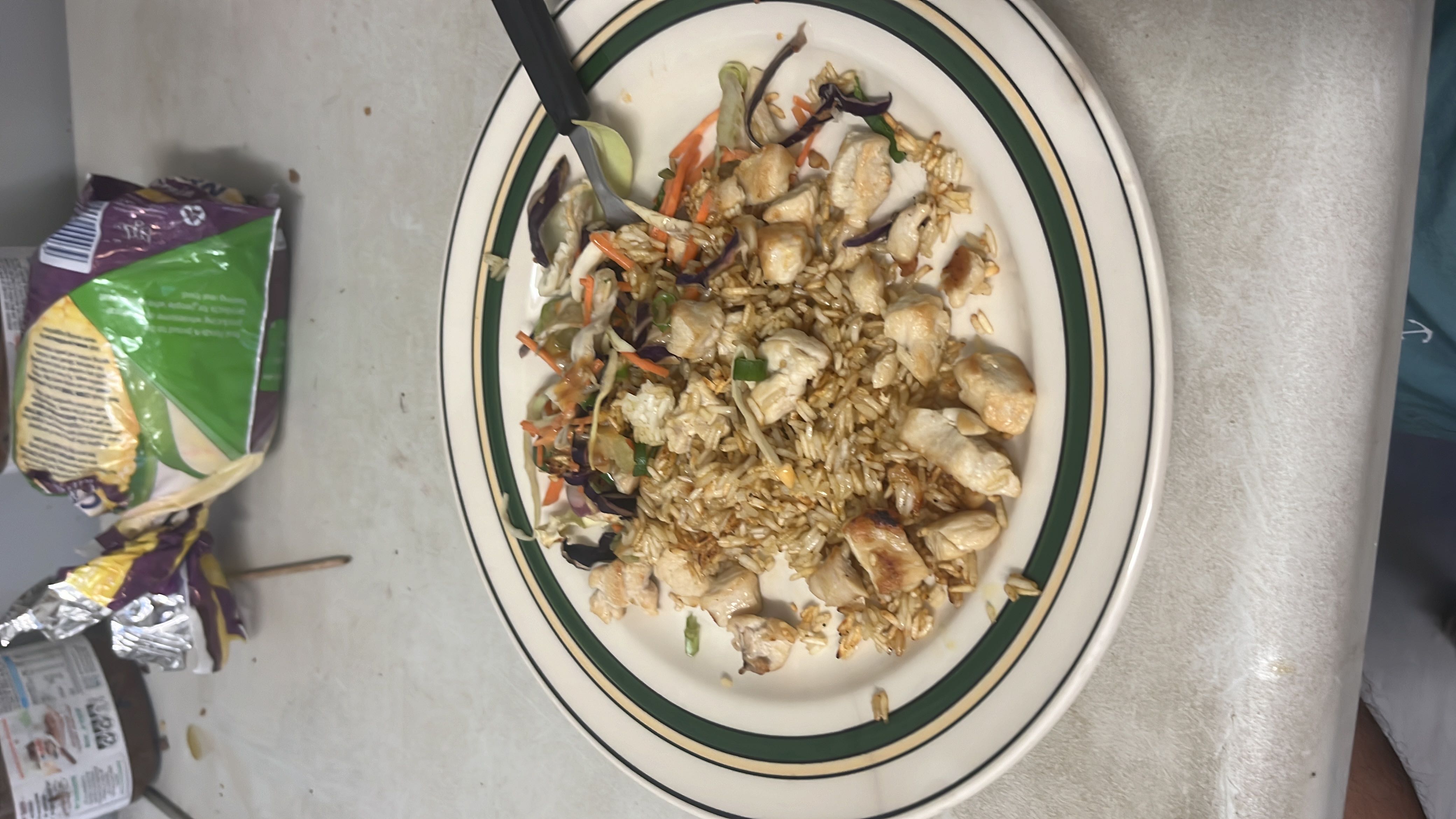 A balanced meal consisting of grilled chicken, rice, and mixed vegetables, providing a good source of protein and moderate carbs.