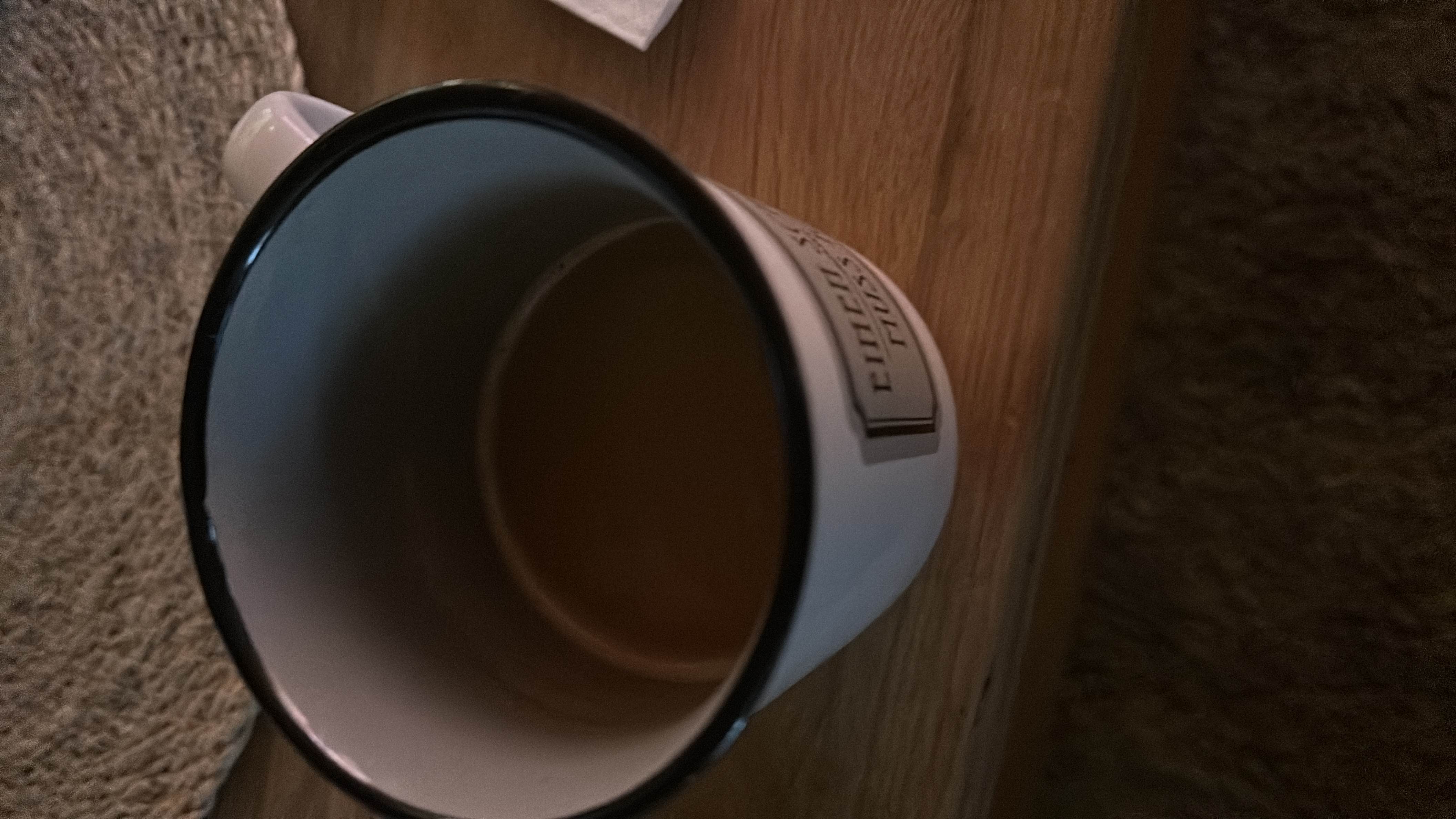 A cup of coffee with milk, providing a moderate amount of calories and a balanced nutritional profile.
