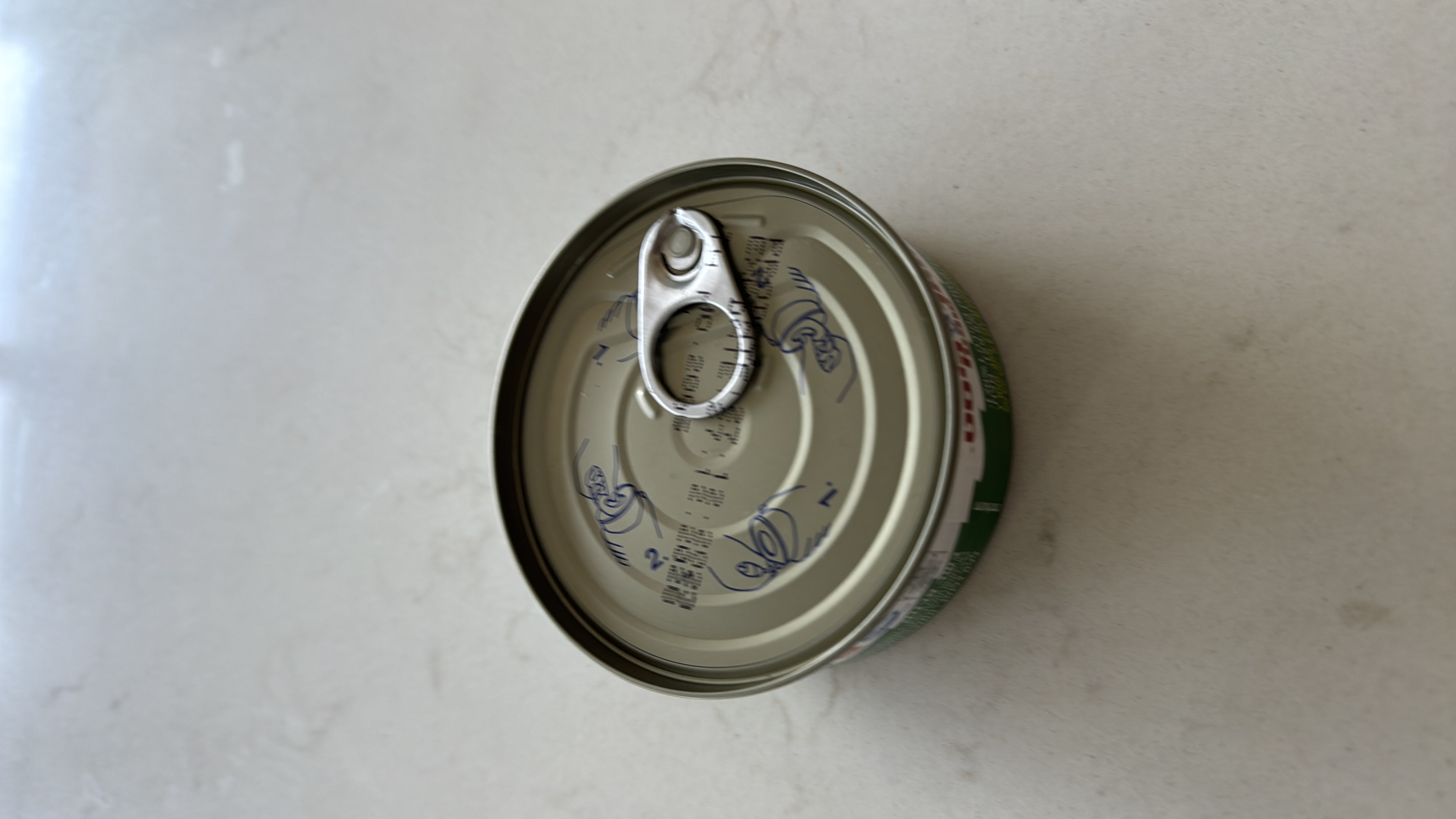 The image shows a sealed canned food item, but no nutritional information is visible.