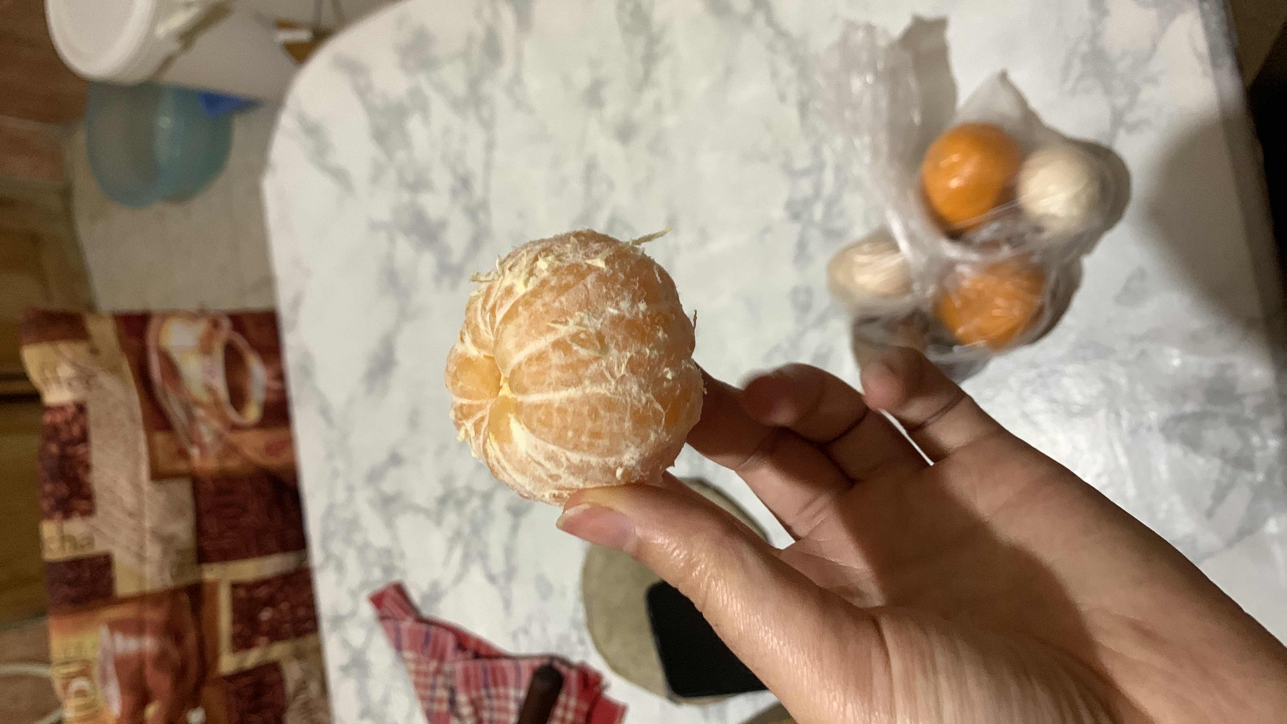 A peeled mandarin orange, a low-calorie fruit rich in vitamin C and dietary fiber.