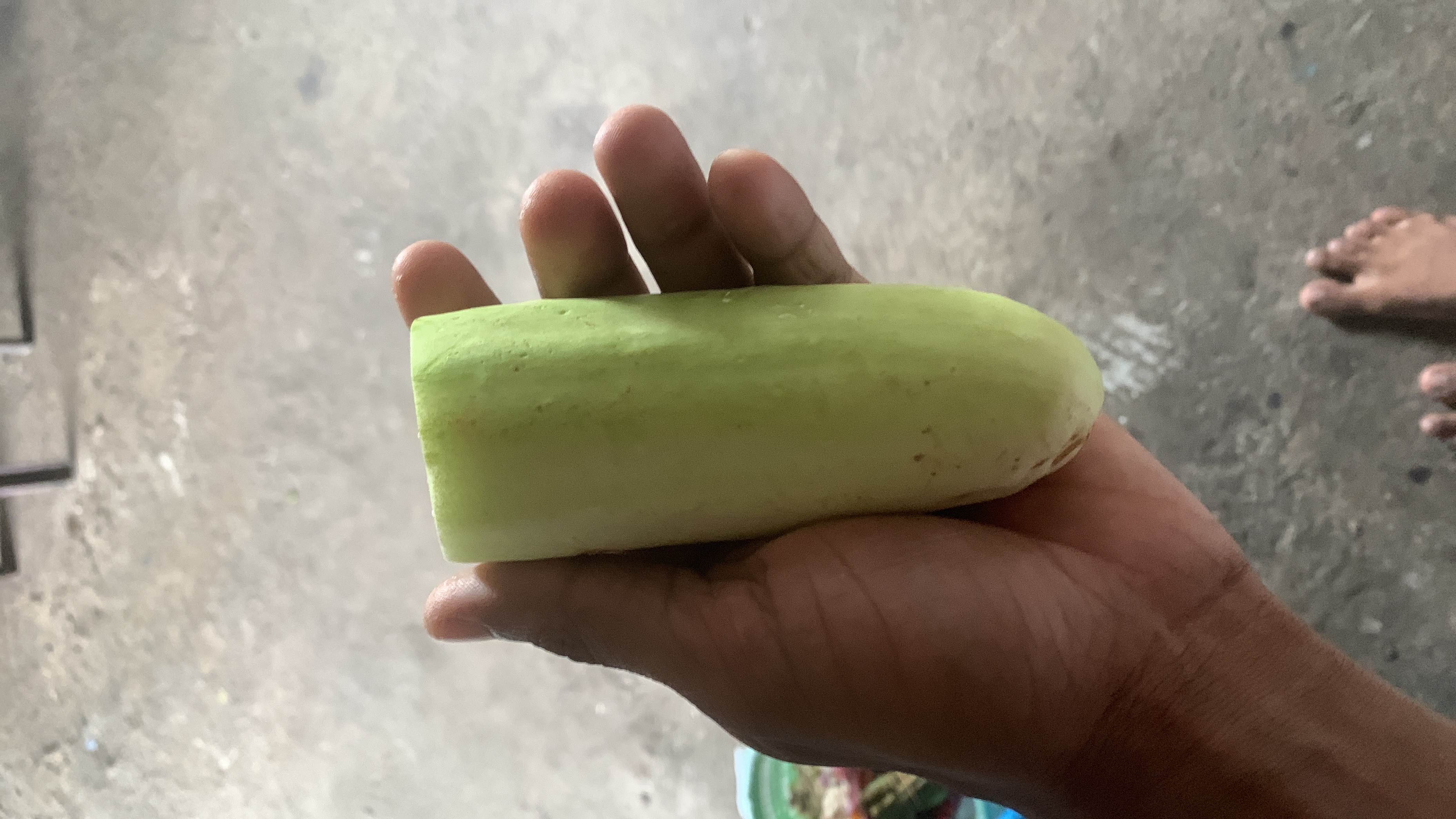 The image shows a peeled cucumber, which is low in calories and contains minimal protein, carbs, and fats, making it a healthy and hydrating food option.