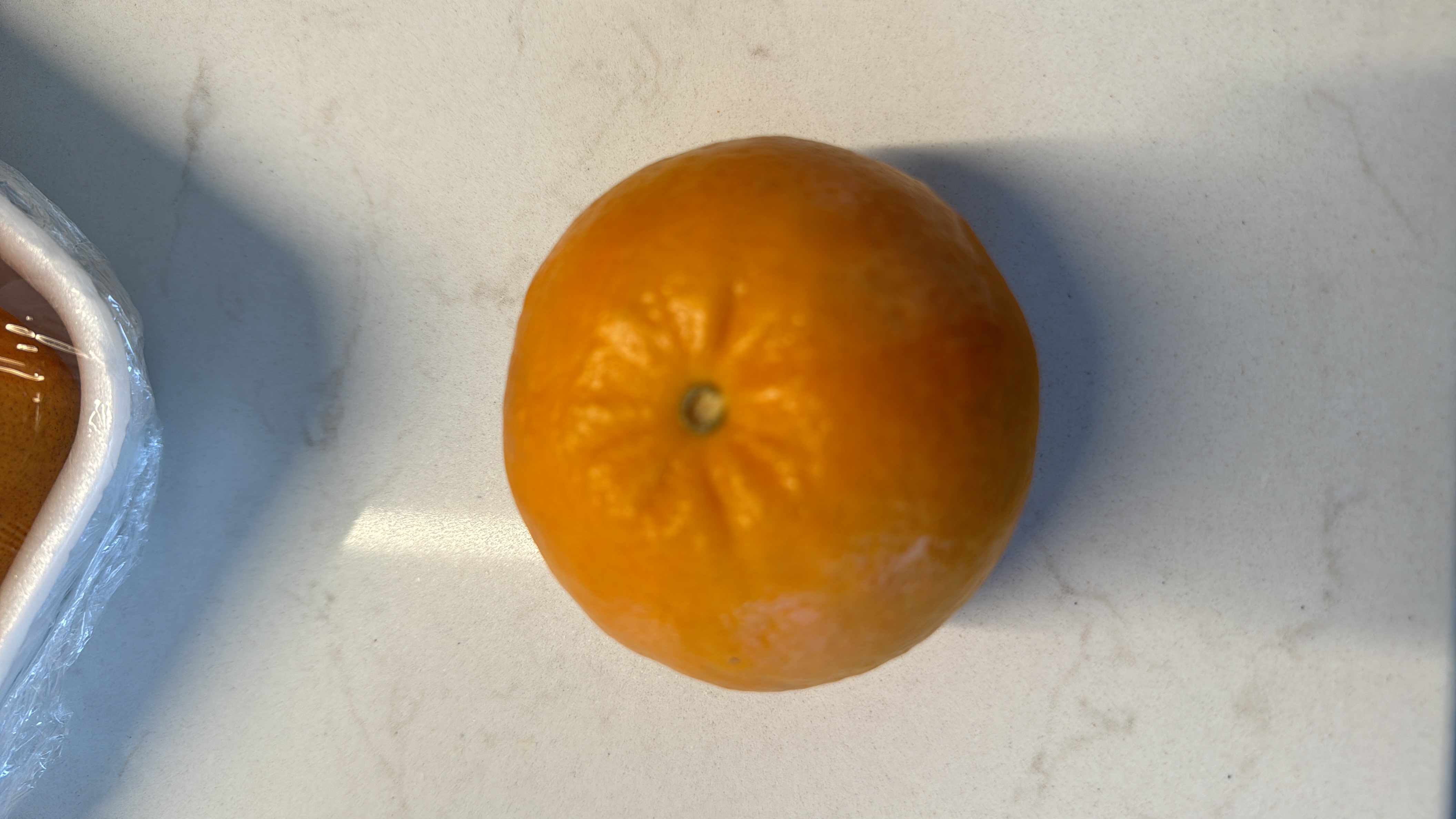 This is a mandarin orange, a low-calorie fruit rich in vitamin C and dietary fiber, making it a healthy snack option.