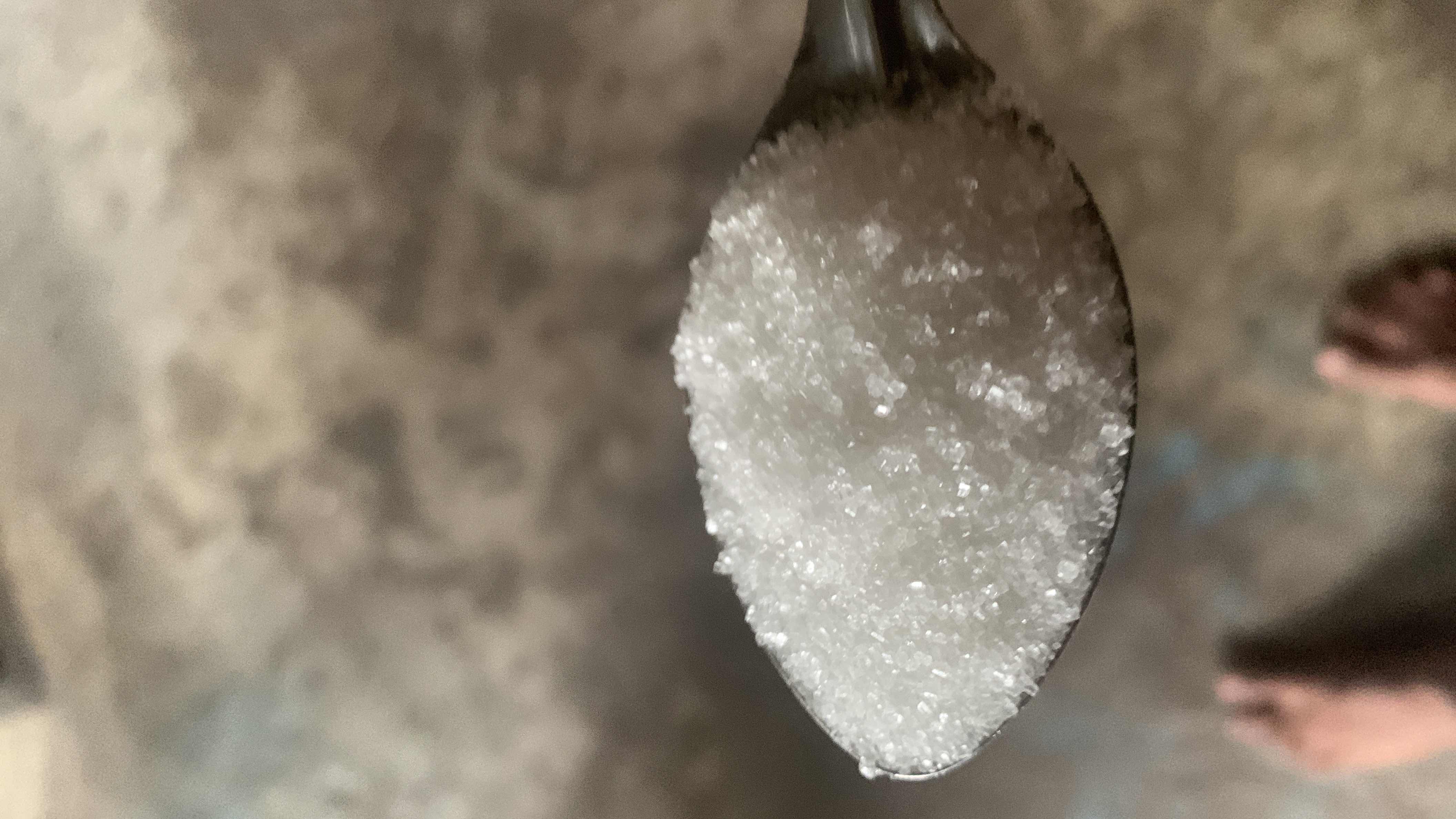 A spoonful of sugar, primarily composed of carbohydrates, providing quick energy but low nutritional value.