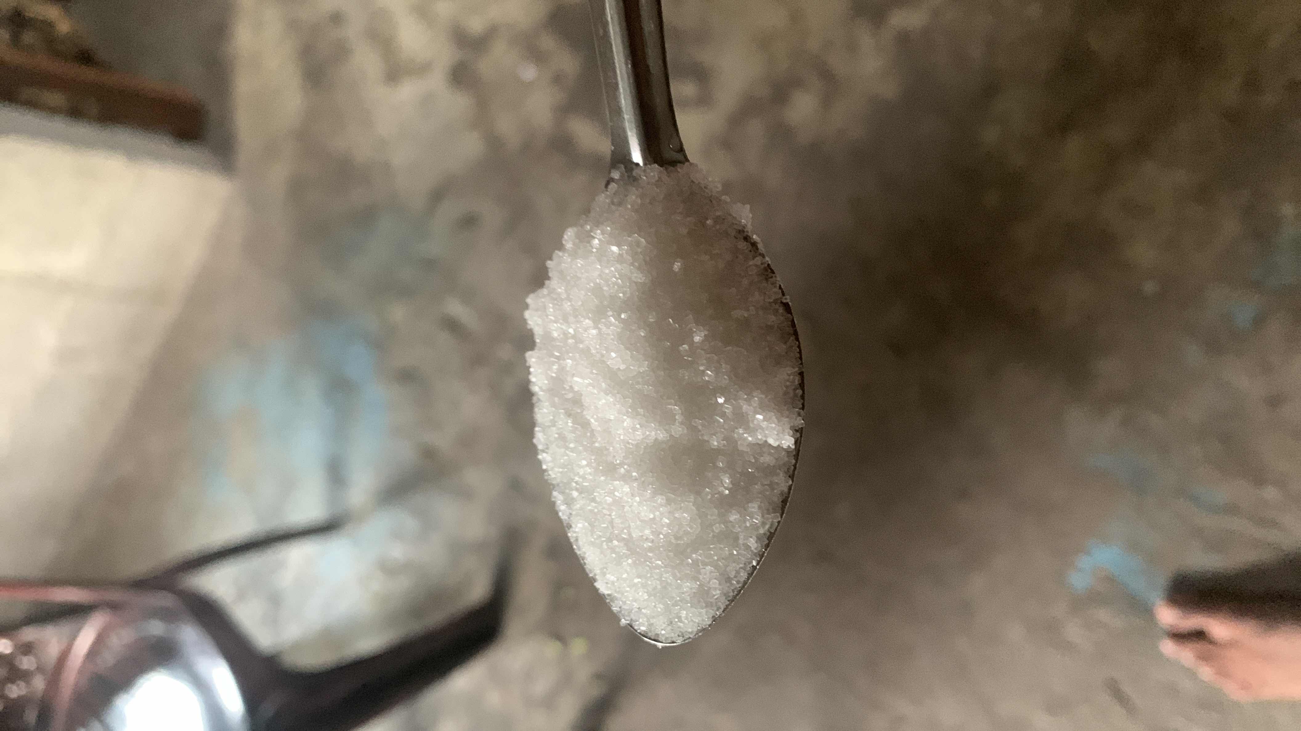 A spoonful of sugar, primarily composed of carbohydrates, providing quick energy but low nutritional value.