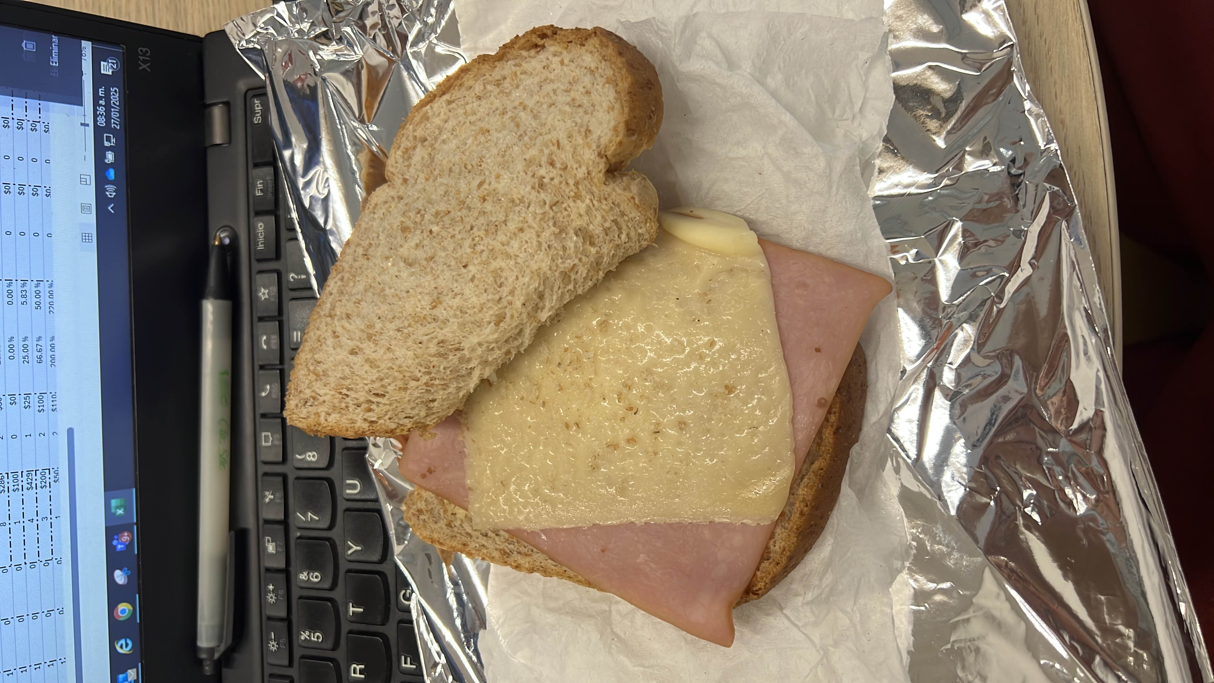 A sandwich made with whole wheat bread, ham, and cheese, providing a balanced mix of protein, carbs, and fats.