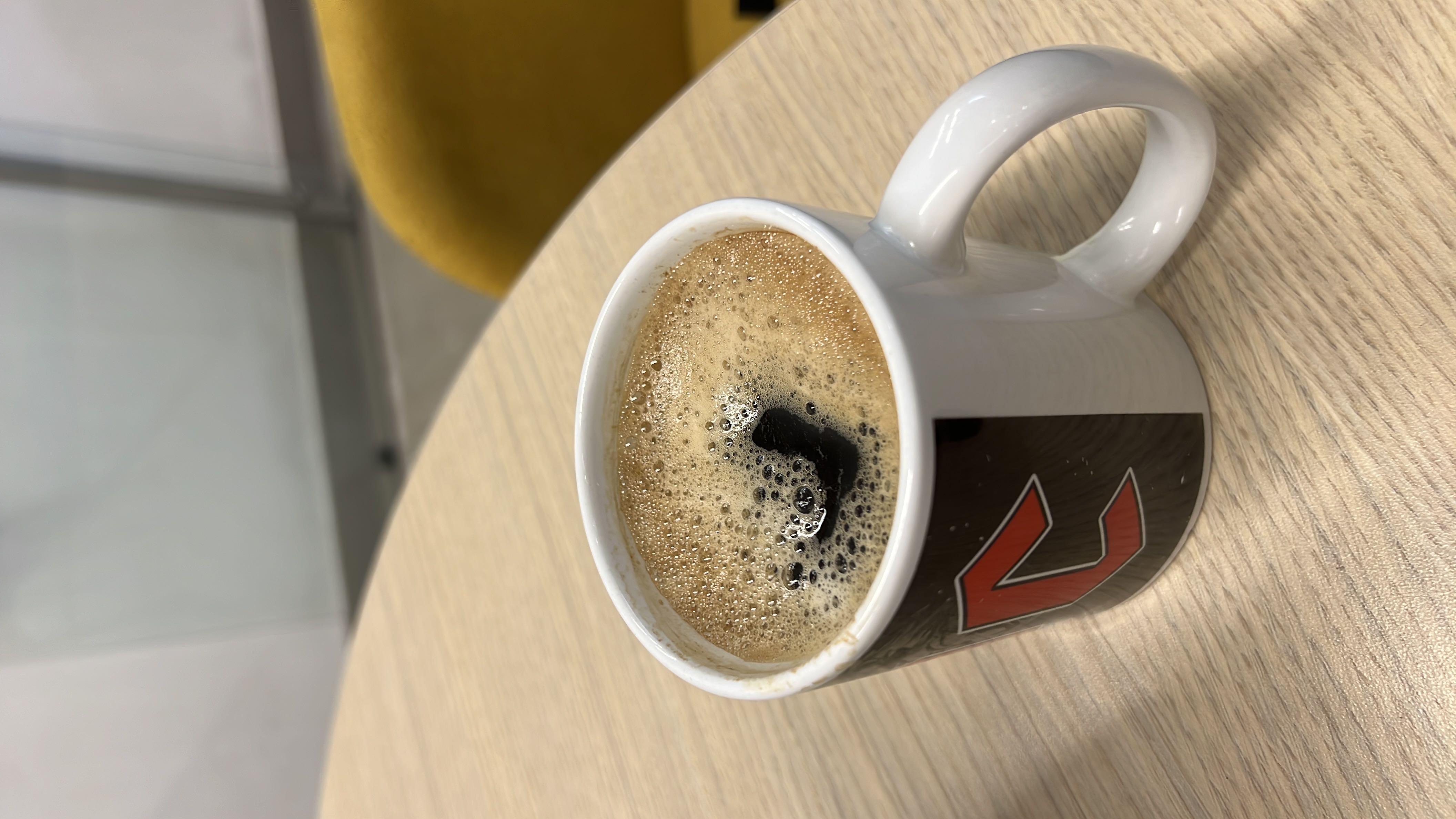A cup of black coffee, low in calories and free of fats and carbs, making it a healthy beverage choice.