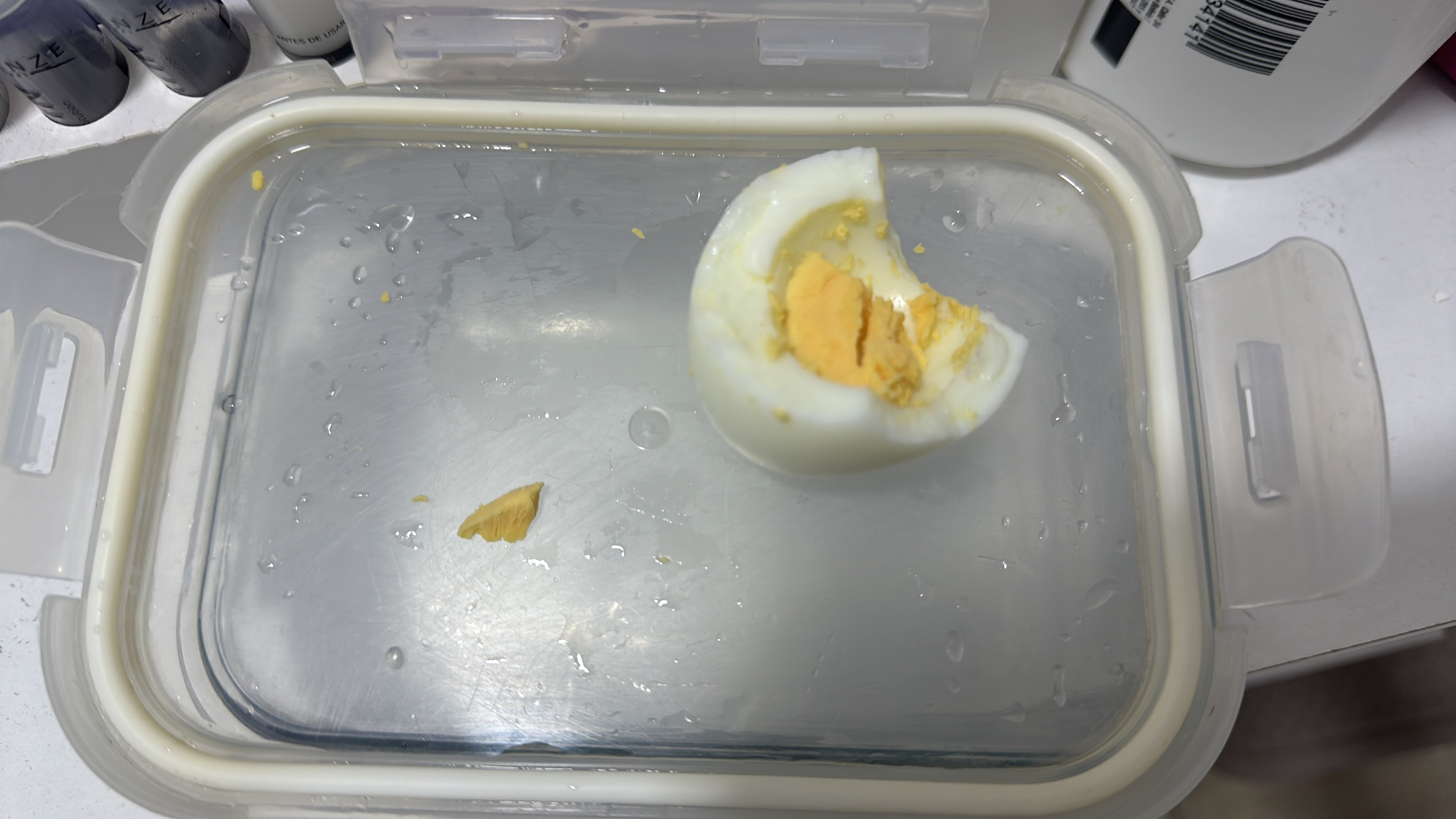 The image shows a partially eaten boiled egg, which is a high-protein, low-carb food item.