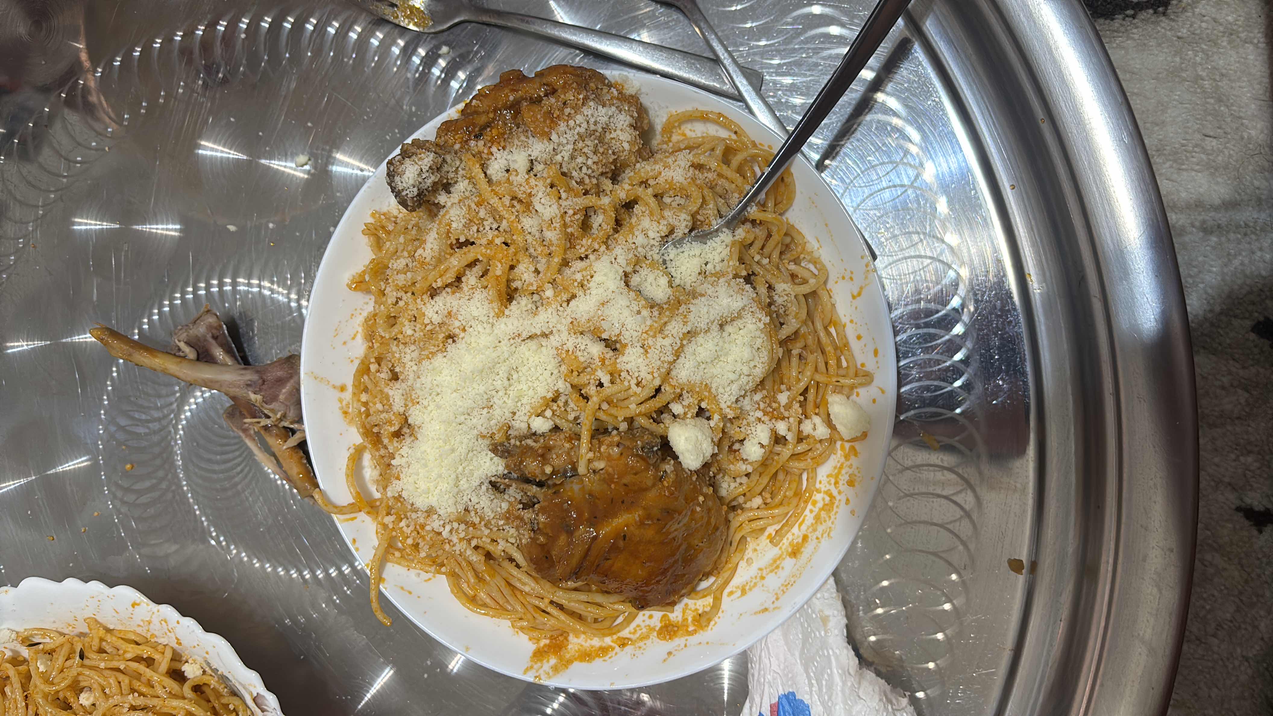 A plate of spaghetti with chicken and parmesan cheese, providing a balanced mix of protein, carbs, and fats.