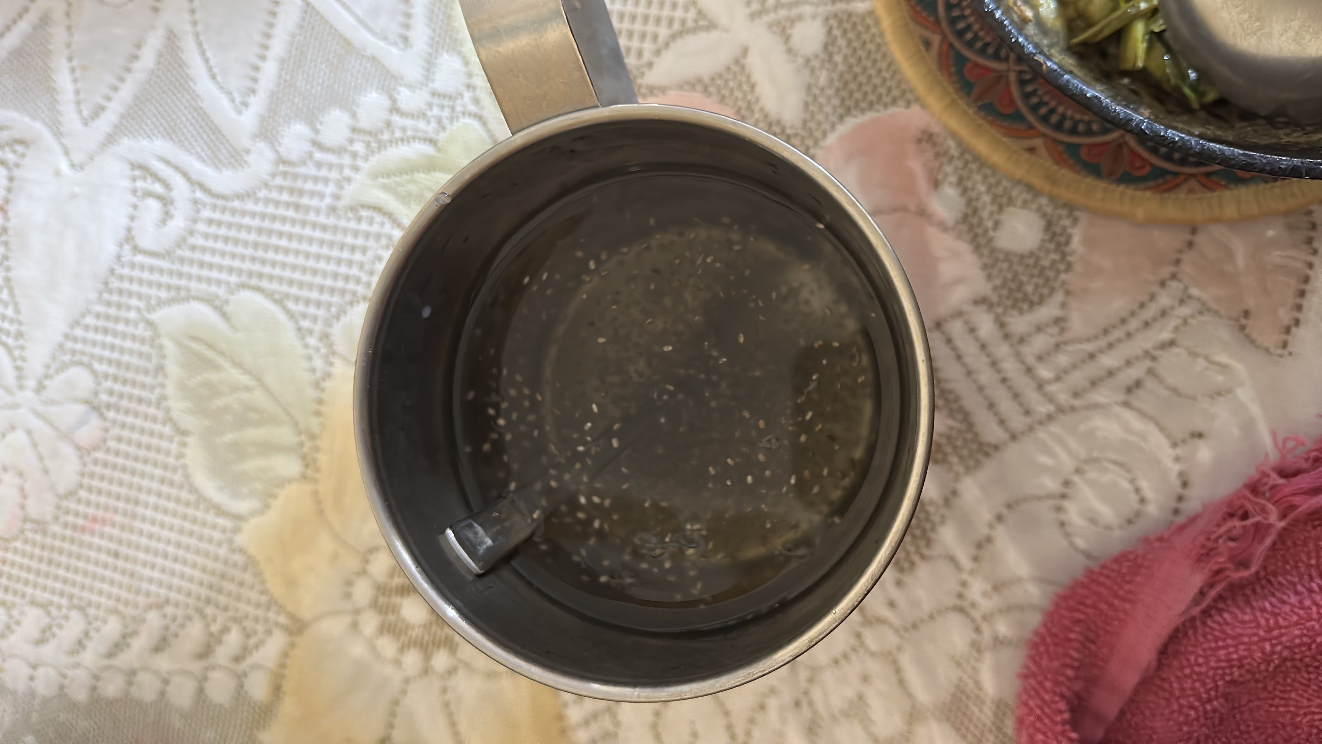 A cup containing water mixed with chia seeds, a low-calorie and nutrient-rich drink.