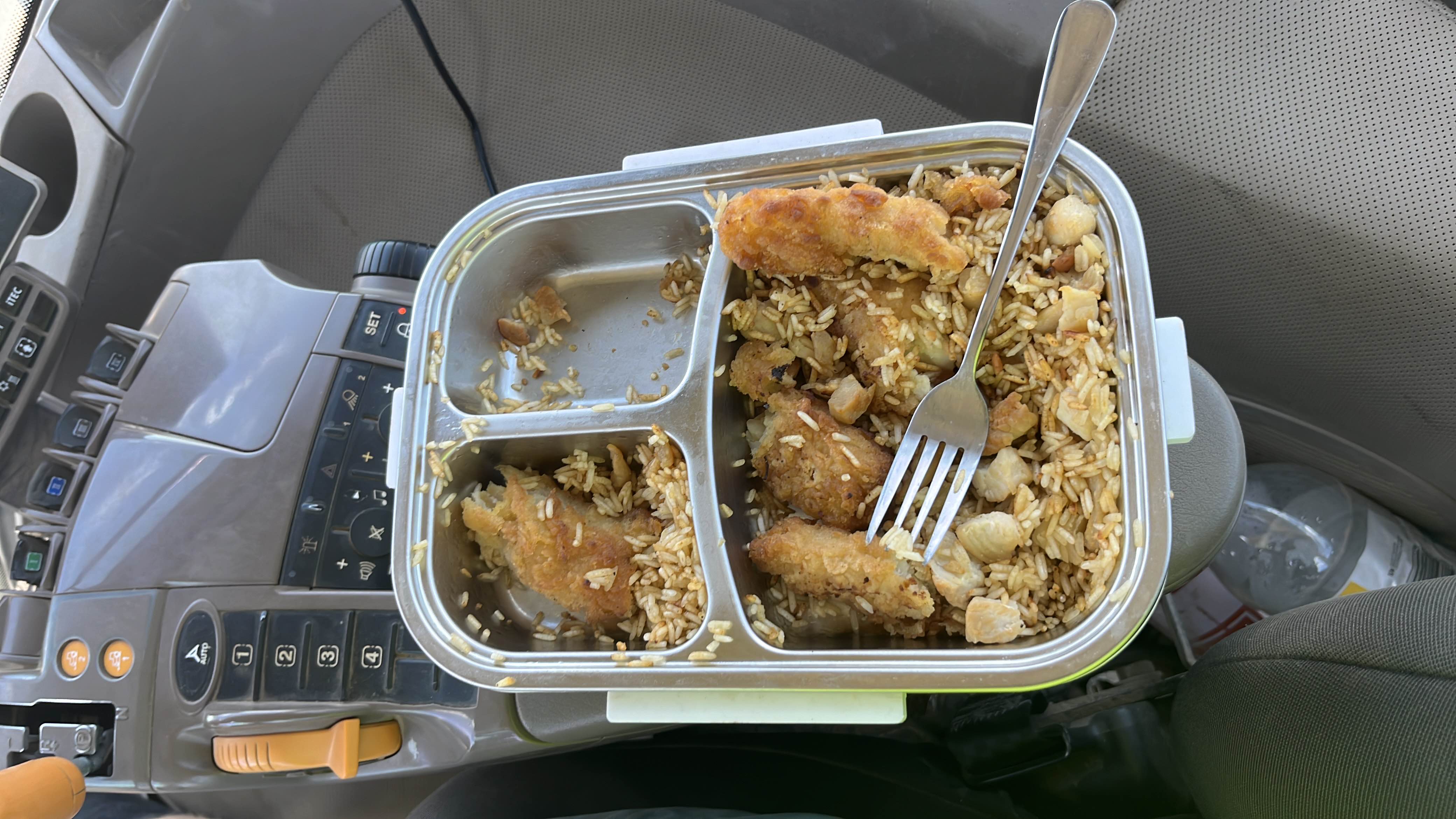 A meal consisting of fried chicken, rice, and nuts, providing a balanced mix of protein, carbs, and fats.