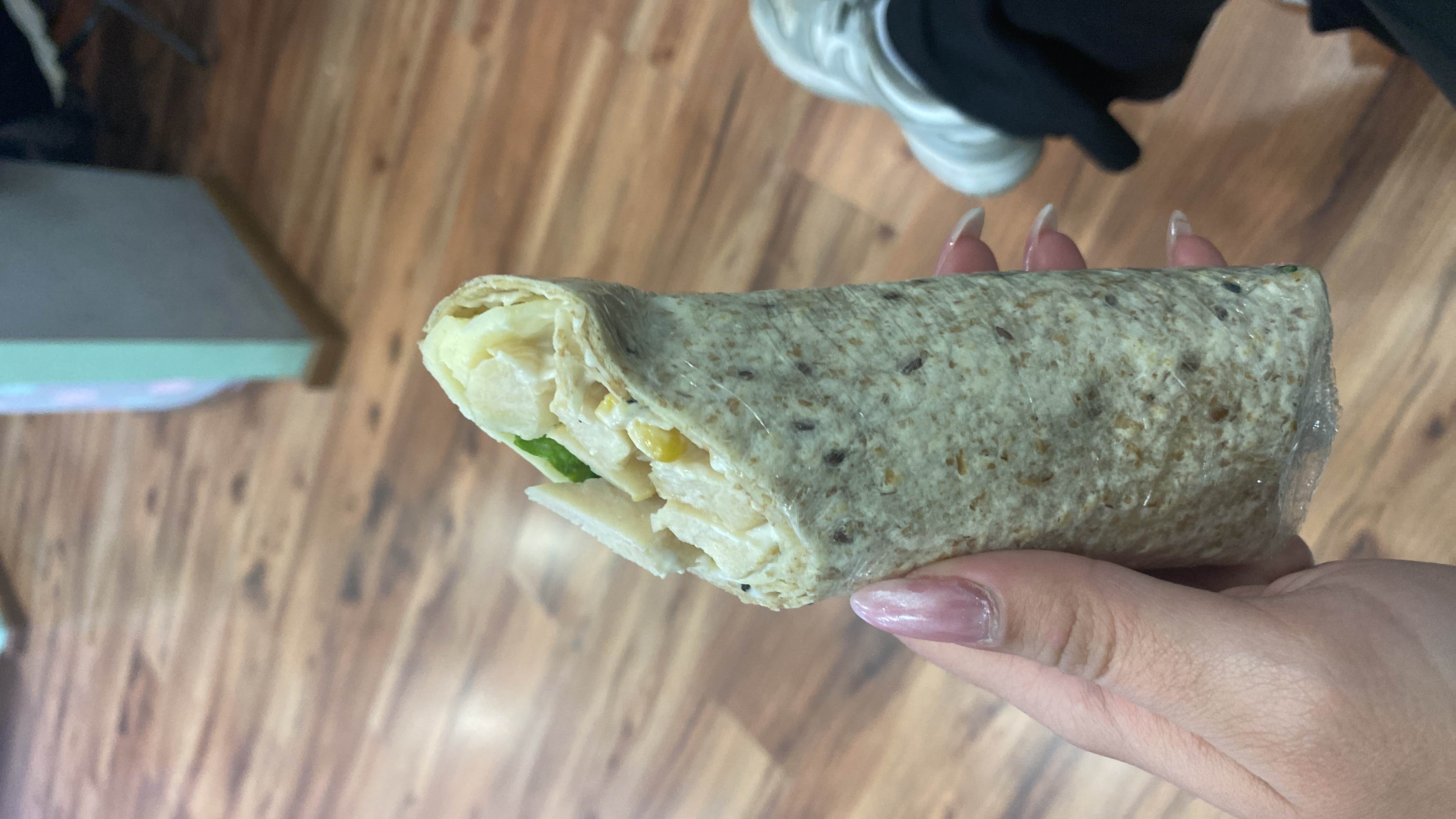 A healthy chicken wrap made with whole wheat, lettuce, corn, and mayonnaise.