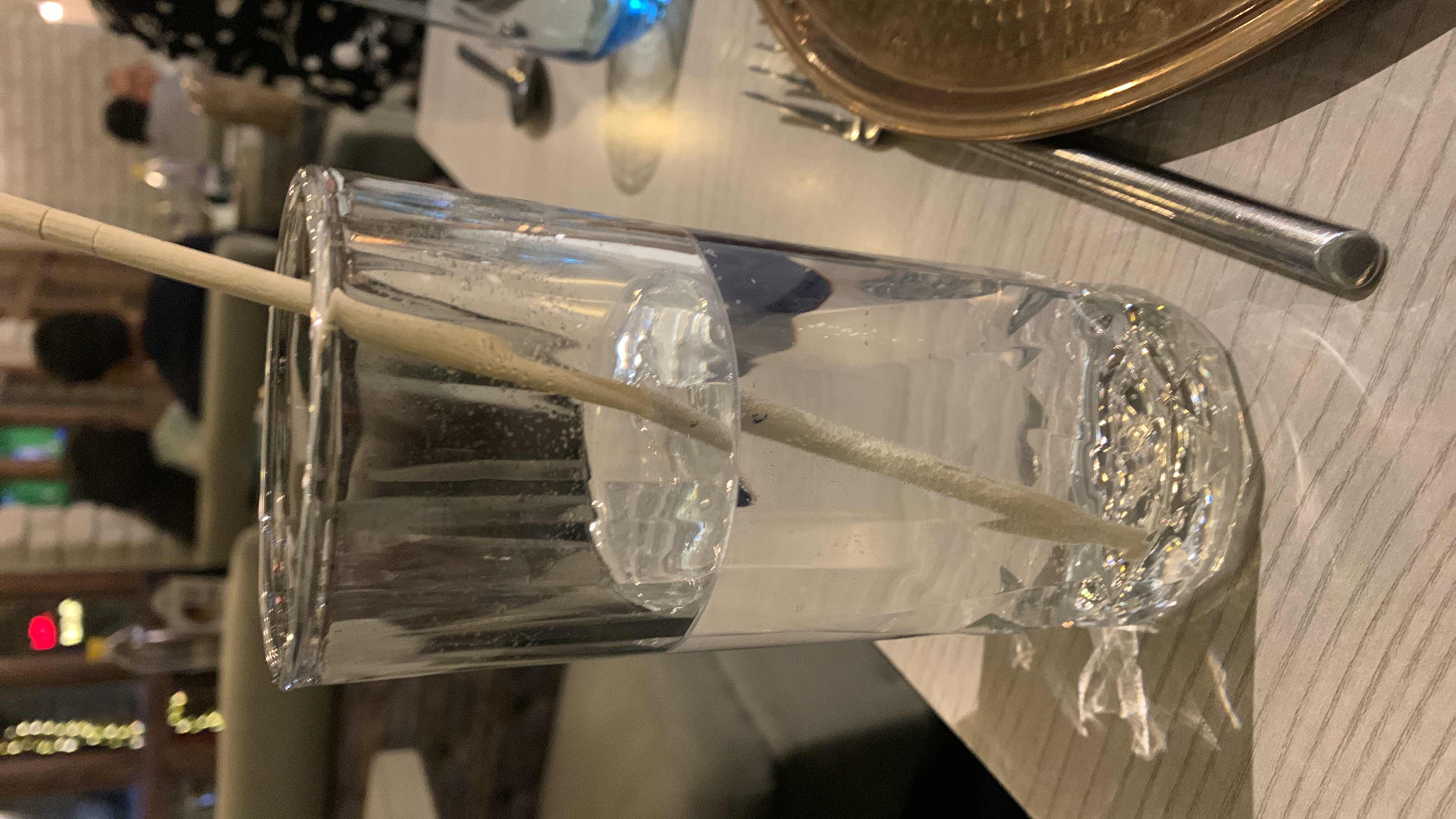 A glass of water with a straw, containing no calories or macronutrients, and is highly hydrating.