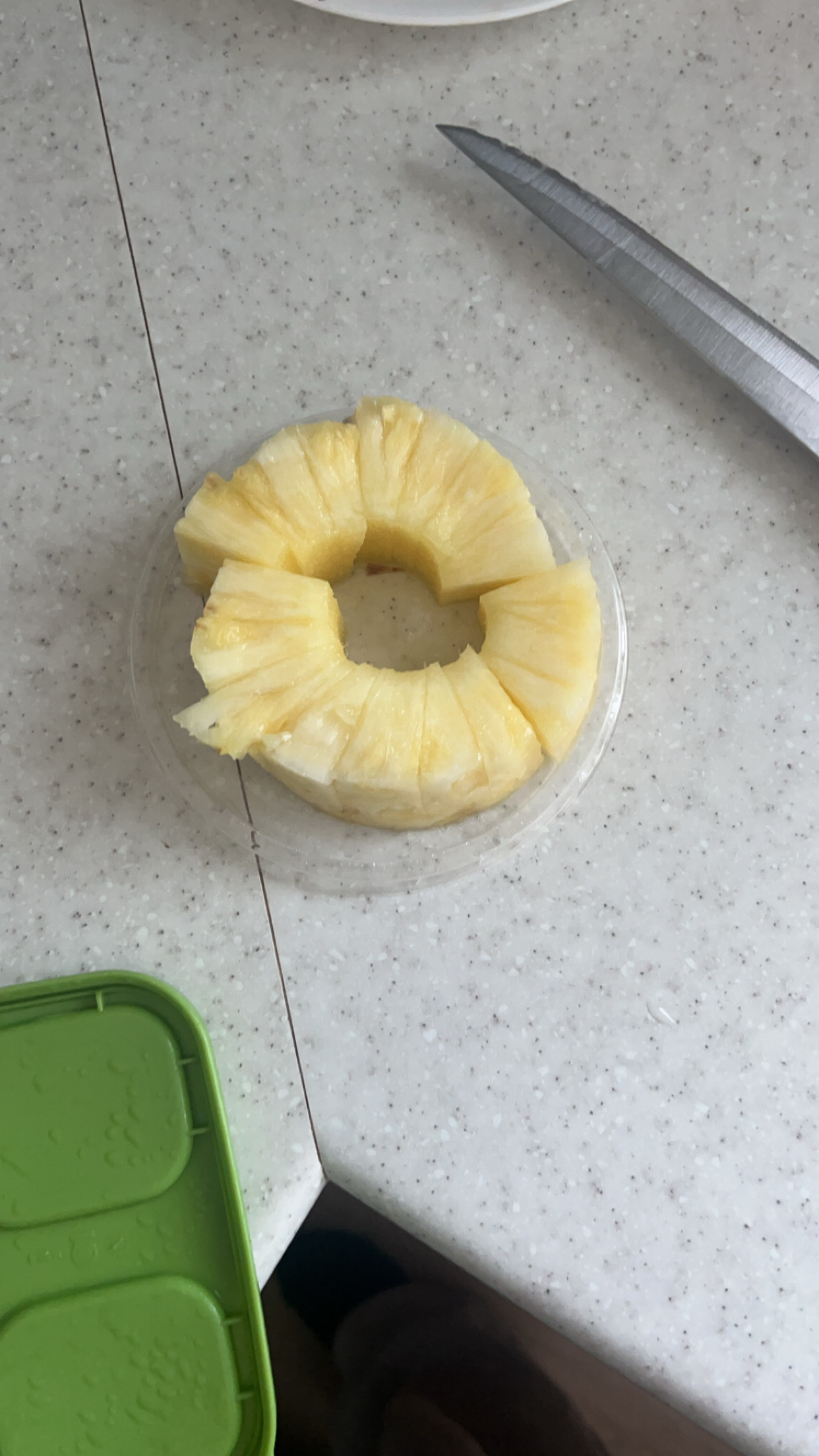 The image shows sliced pineapple, a low-calorie fruit rich in carbohydrates and minimal protein and fat.